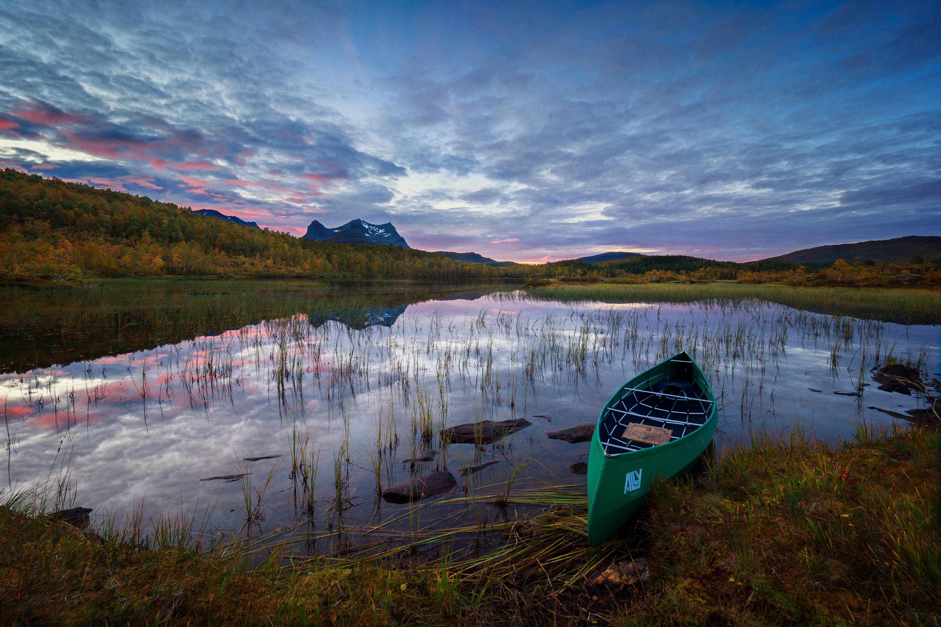 Green canoe on a lake at sunset in Sulitjelma, Norway HD Wallpaper