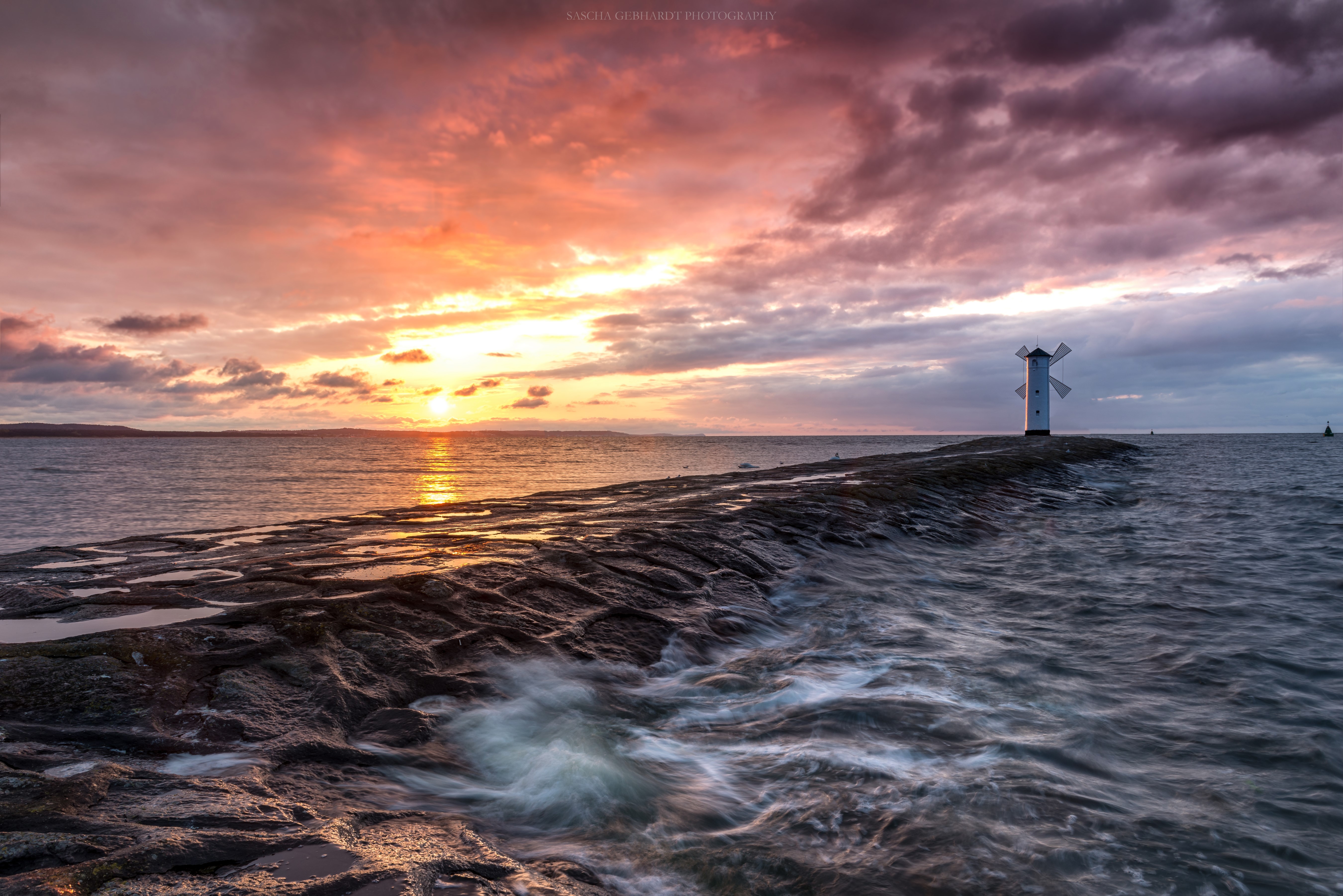 Sunset over the sea with a lighthouse in Poland HD Wallpaper