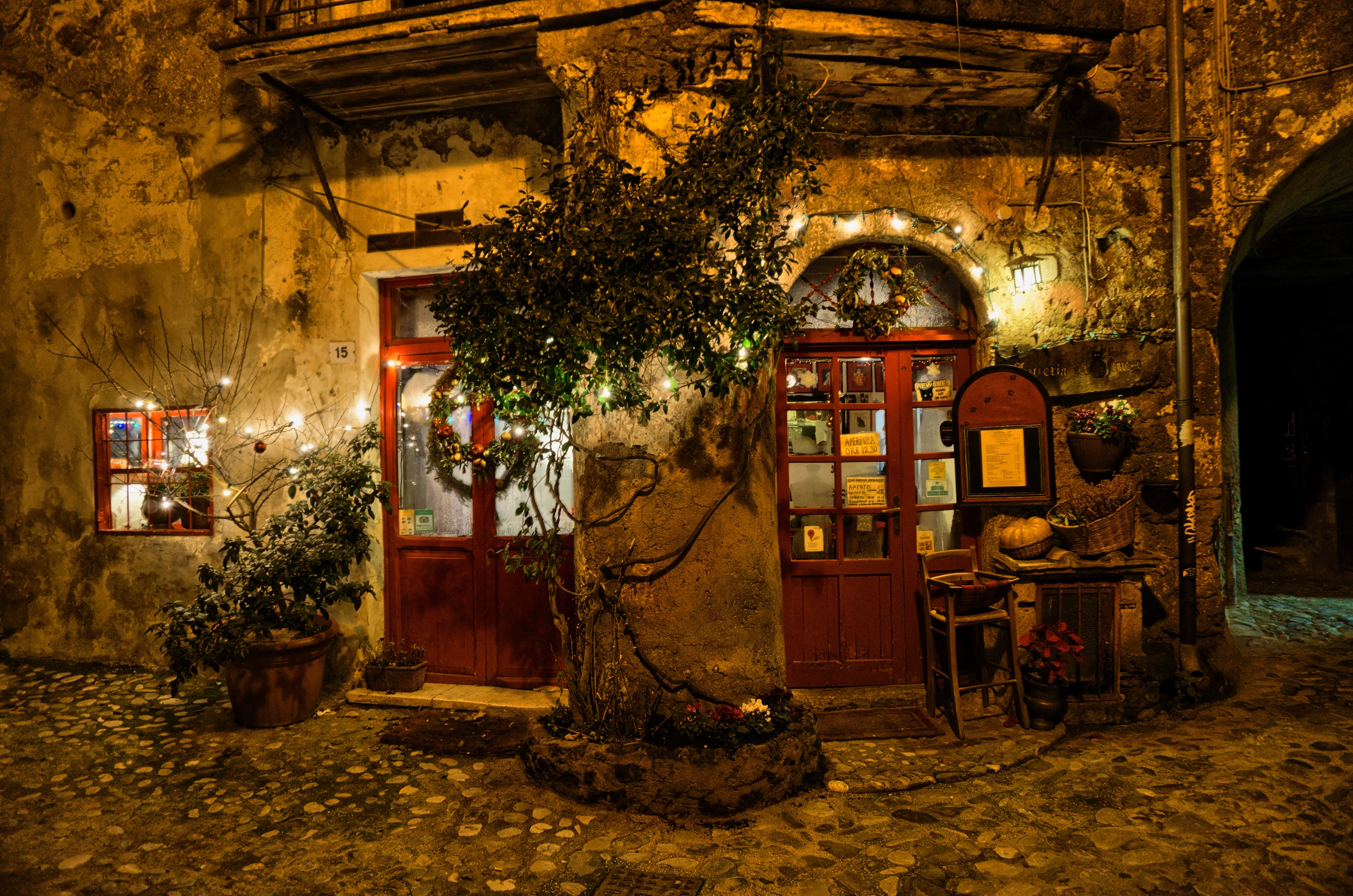 Calcata, Italy: Festive decorated storefront at night HD Wallpaper