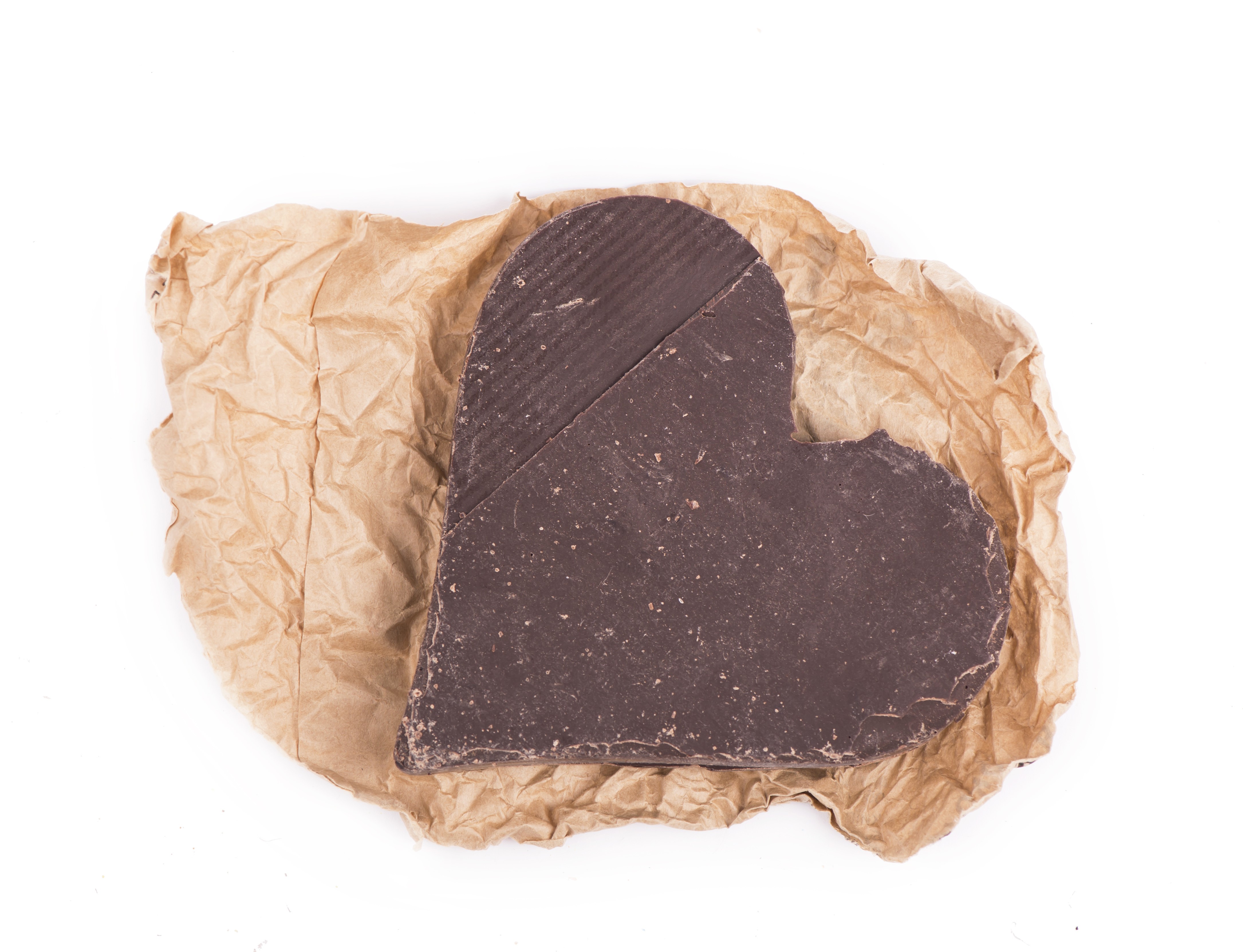 Heart-shaped dark chocolate on brown paper HD Wallpaper