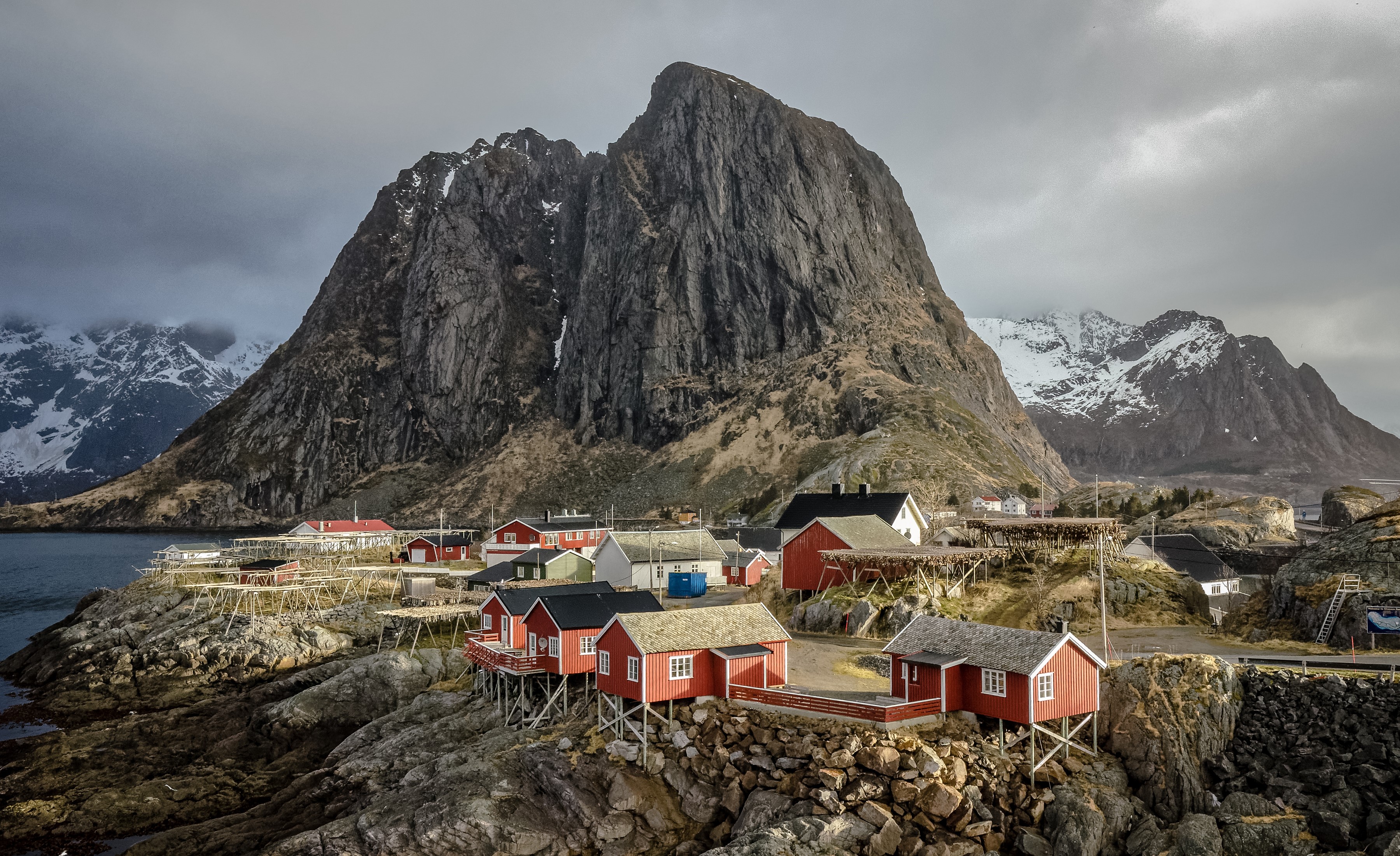 Red houses on rocky shore with mountain in Lofoten, Norway HD Wallpaper