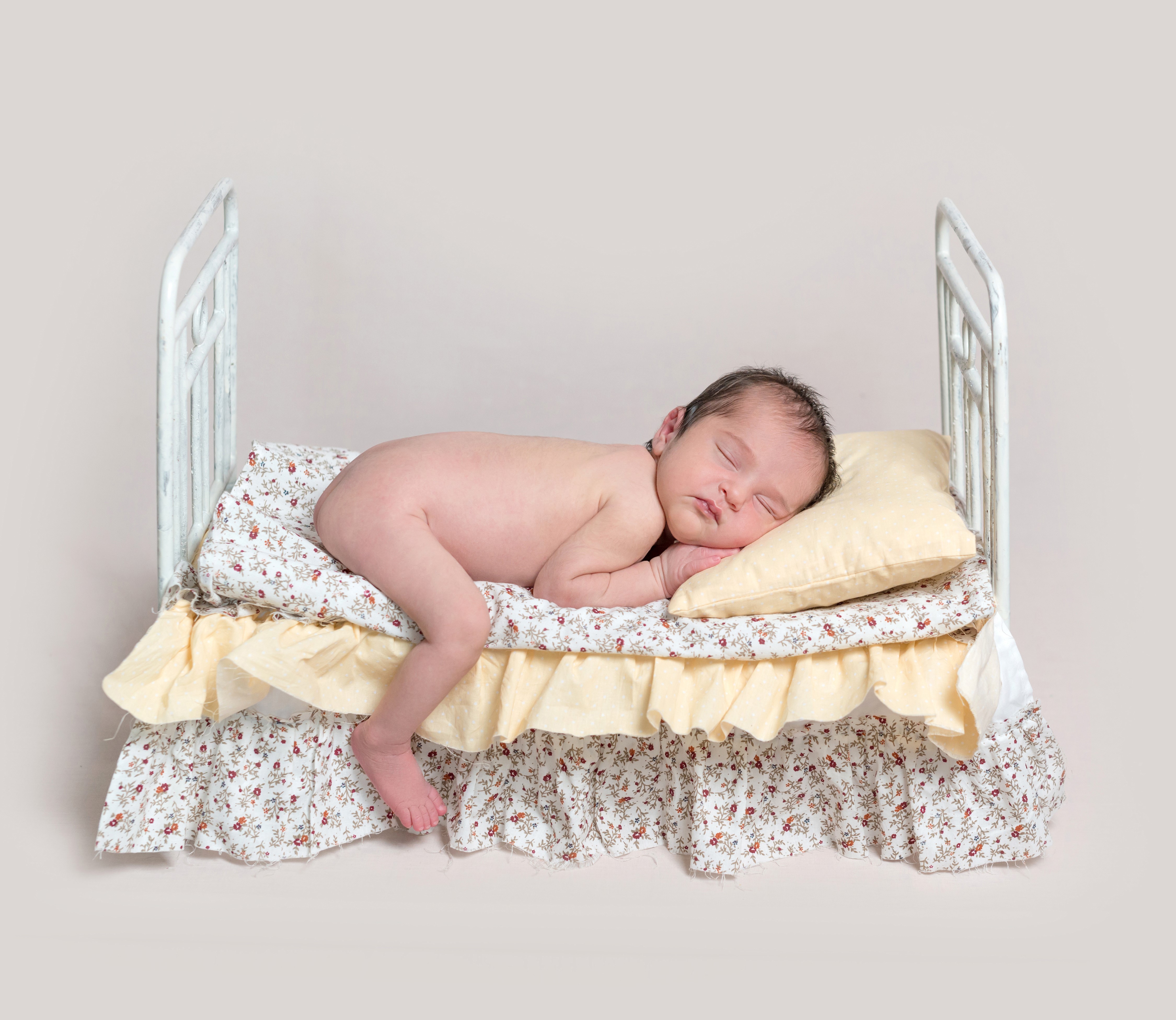Infant sleeping on a bed HD Wallpaper