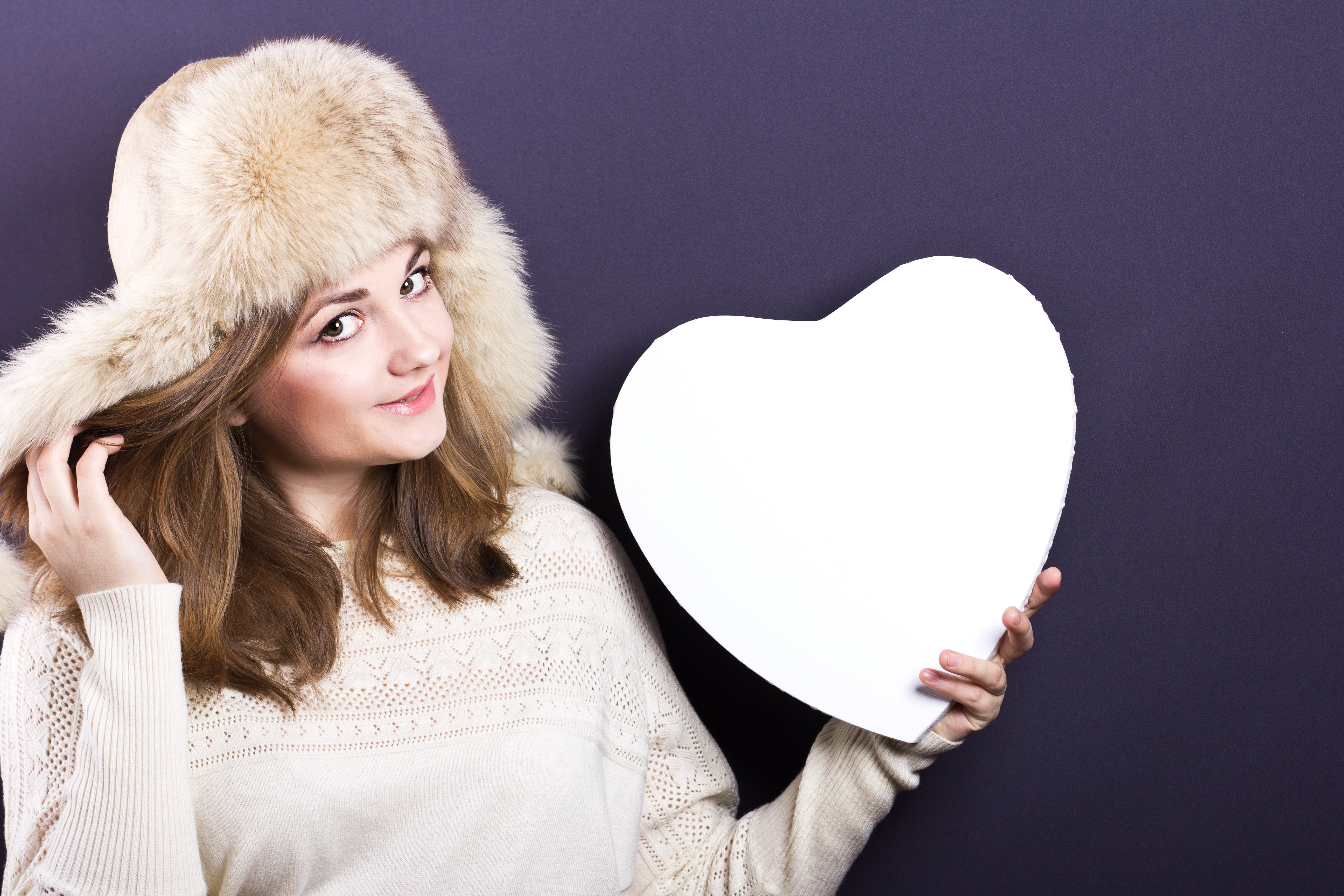Woman in Winter Hat Holding White Heart HD Wallpaper