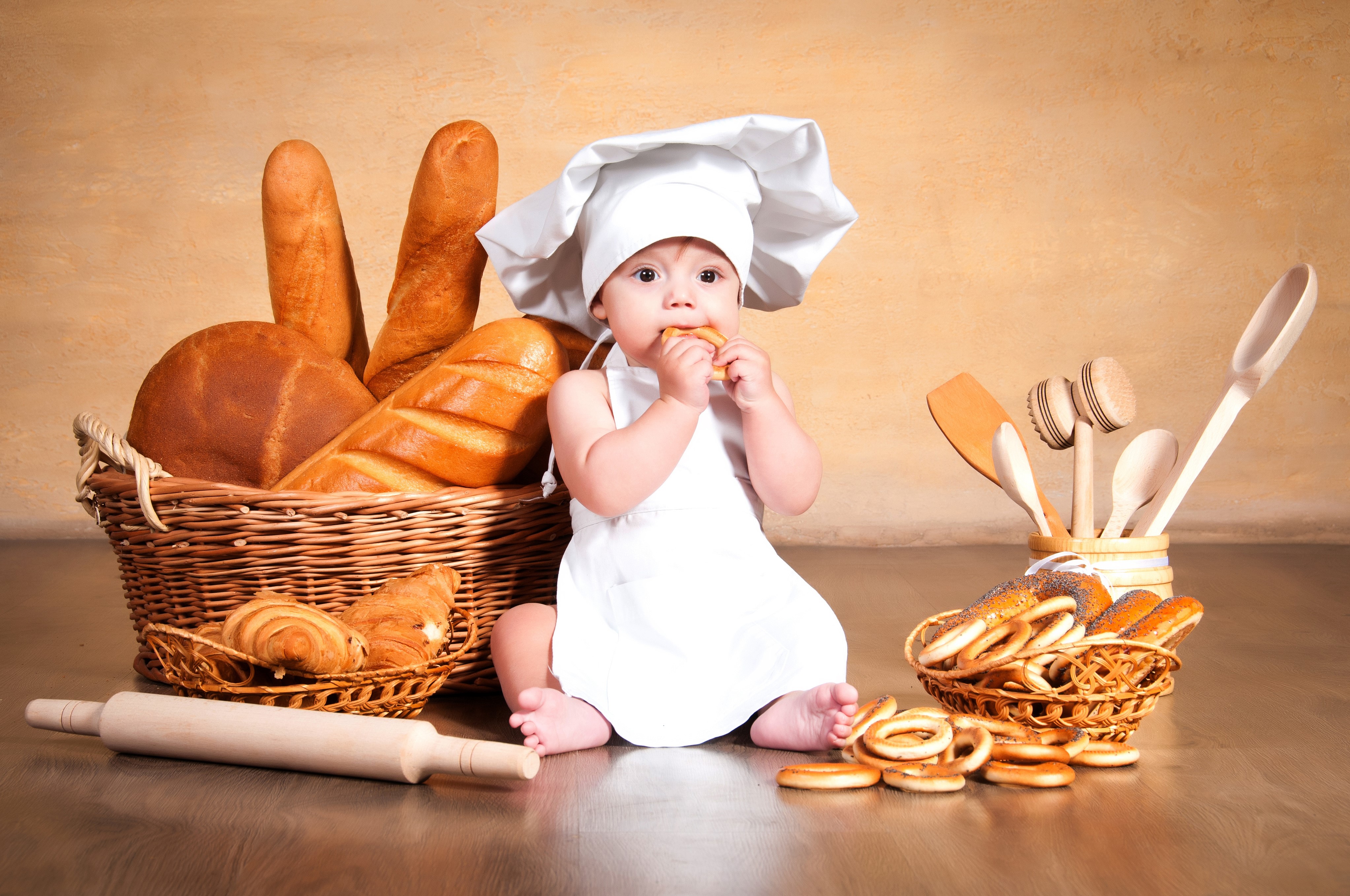 Baby Chef Eating Pastry with Bread and Baking Utensils HD Wallpaper