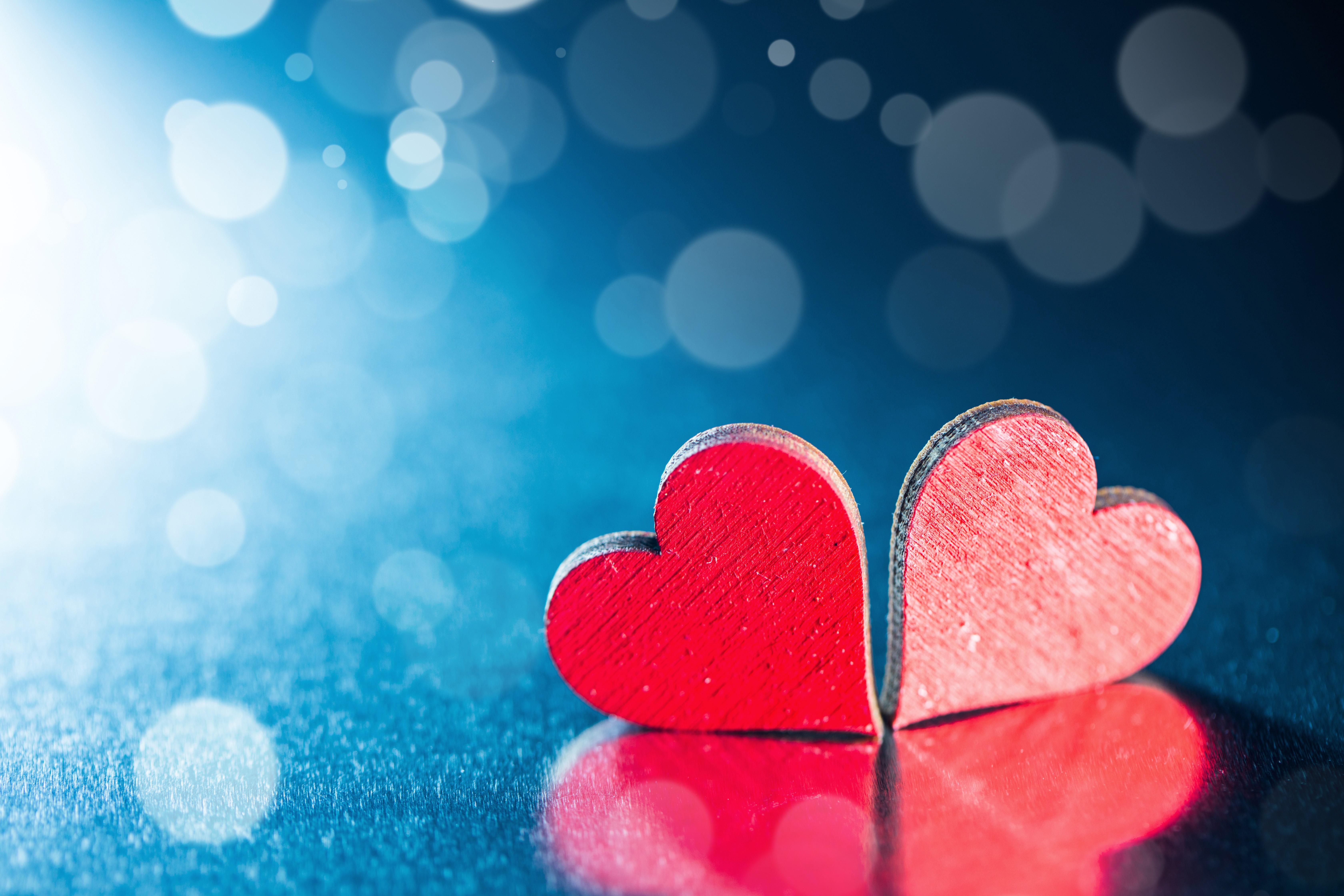 Two red hearts on a blue background HD Wallpaper