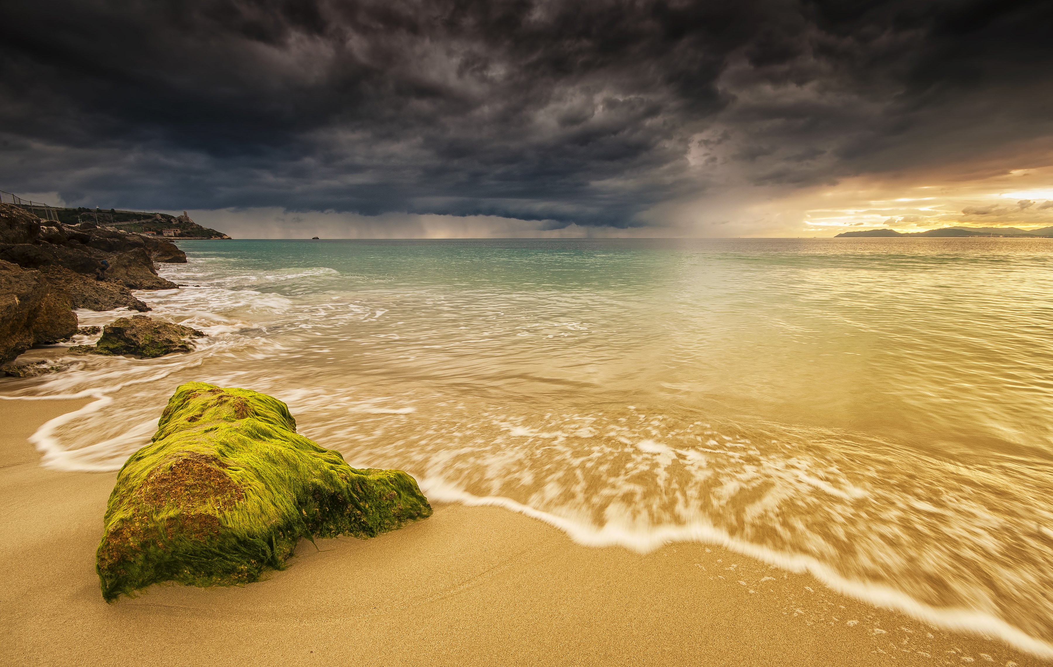 Stormy sky over a rocky coast and beach in Sardinia HD Wallpaper