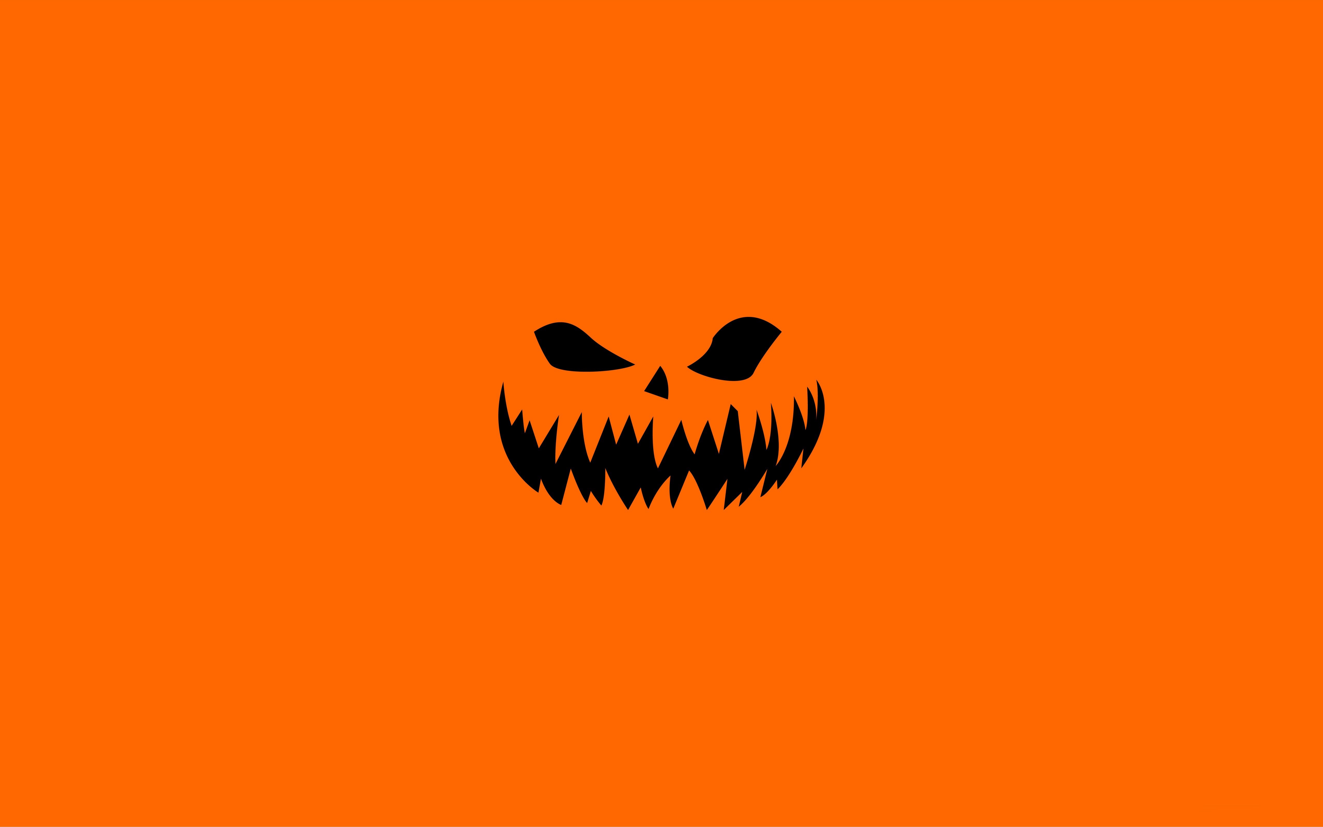 Halloween pumpkin face on orange background HD Wallpaper