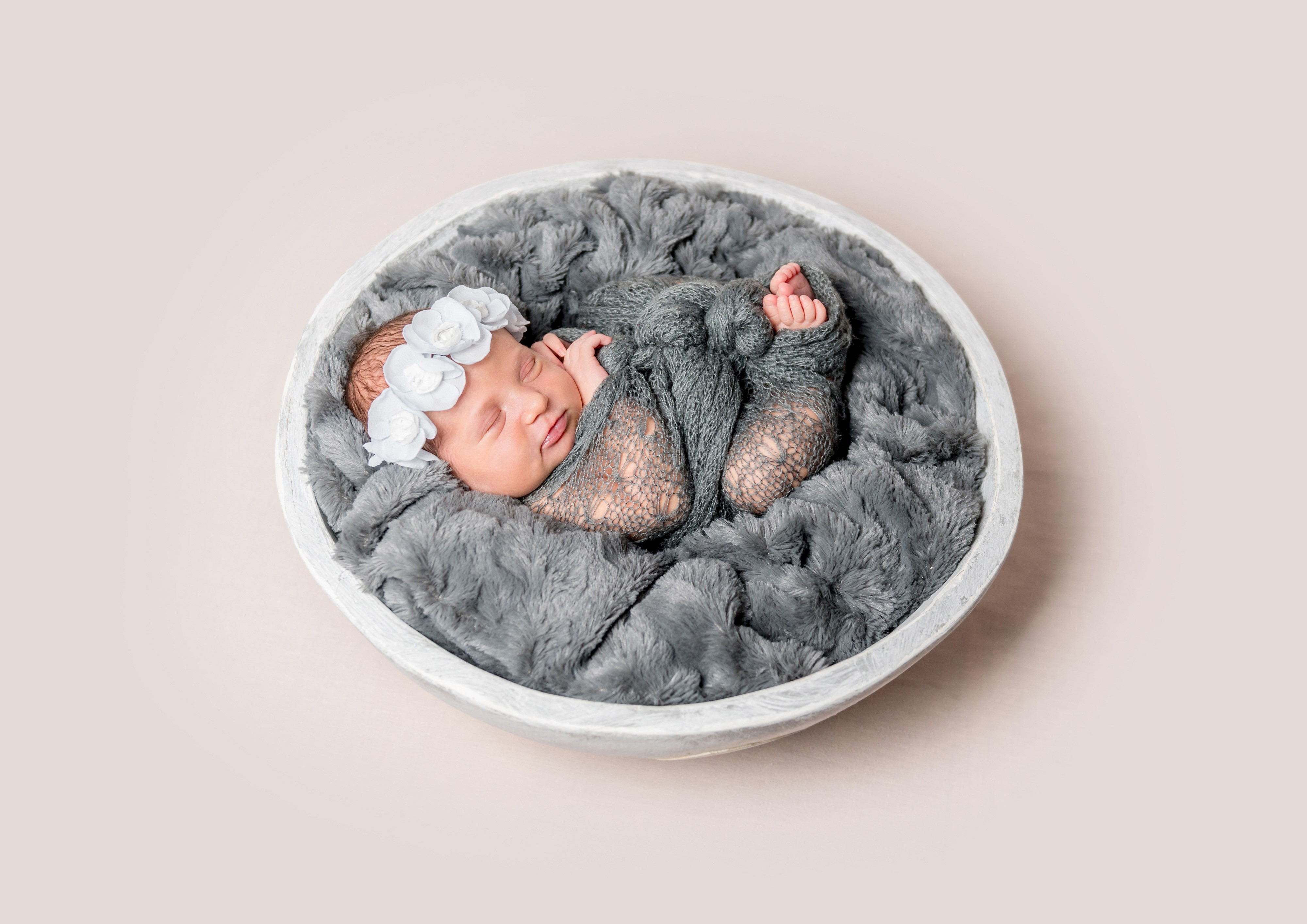 Newborn baby sleeping in a bowl HD Wallpaper