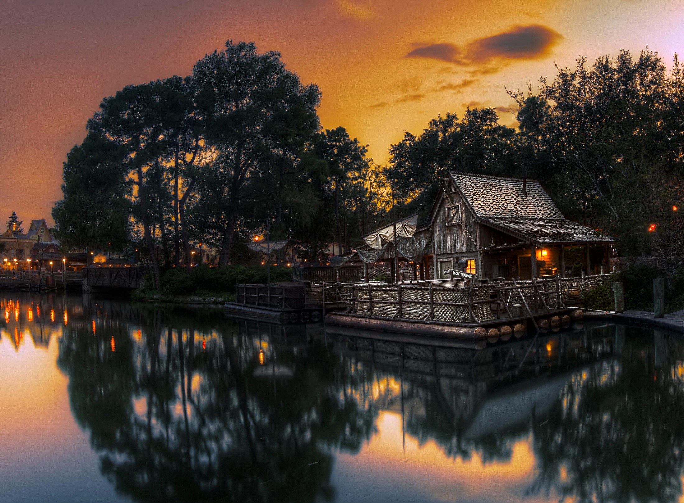 Wooden house on a raft by a pond at dusk HD Wallpaper