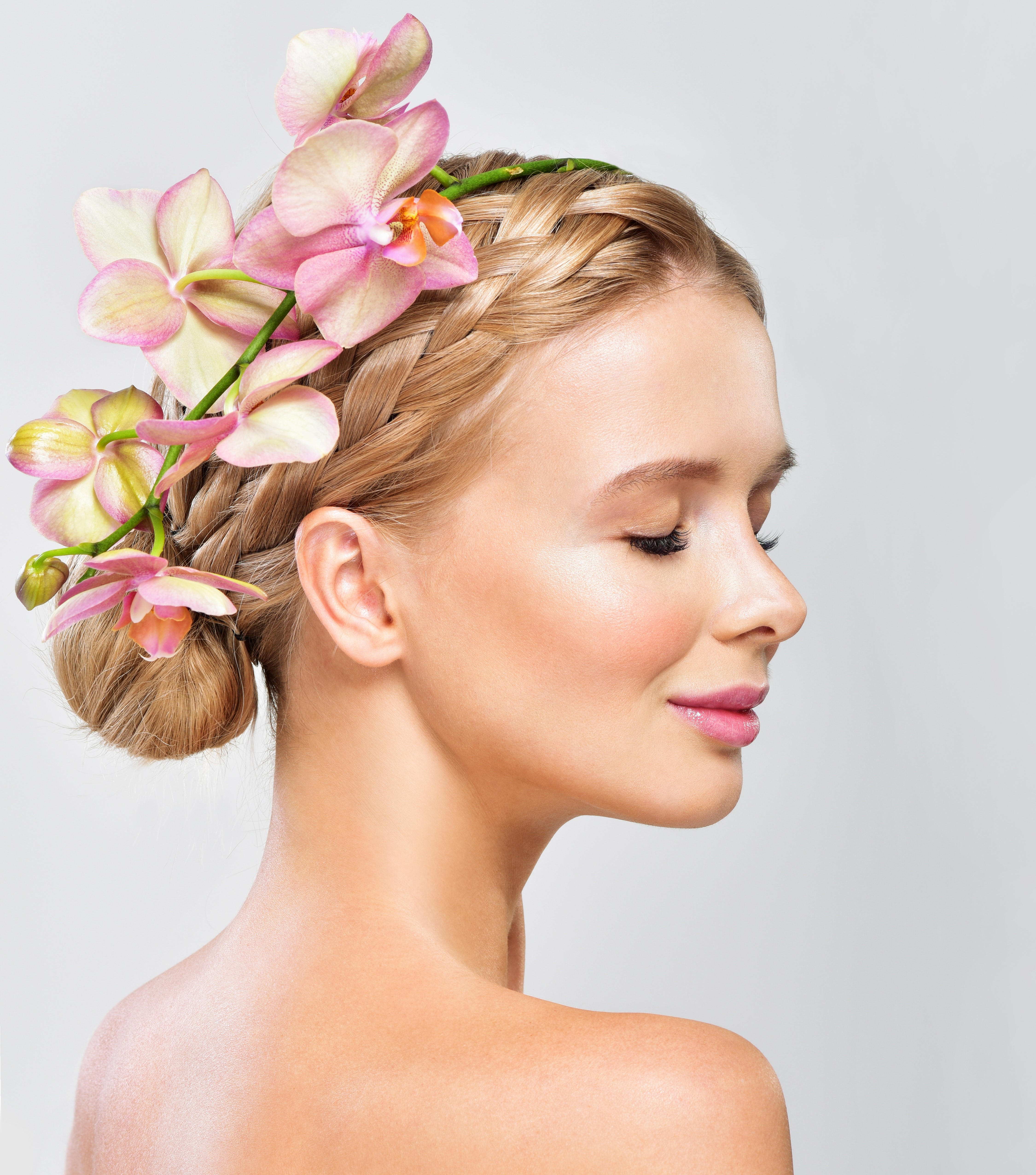Blonde girl with orchid in hair on gray background HD Wallpaper