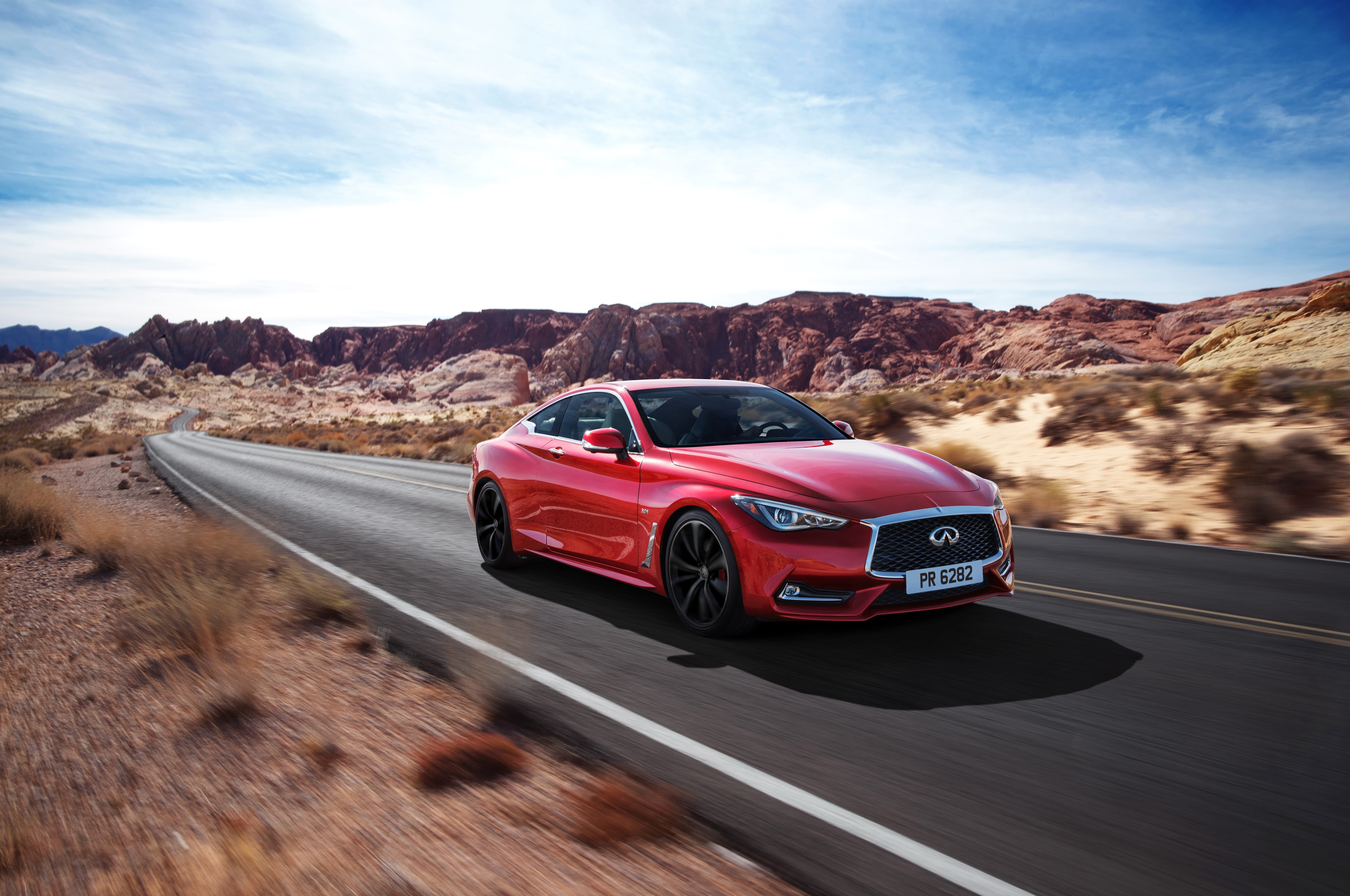 Red Infiniti Q60 Coupe driving on a desert road HD Wallpaper