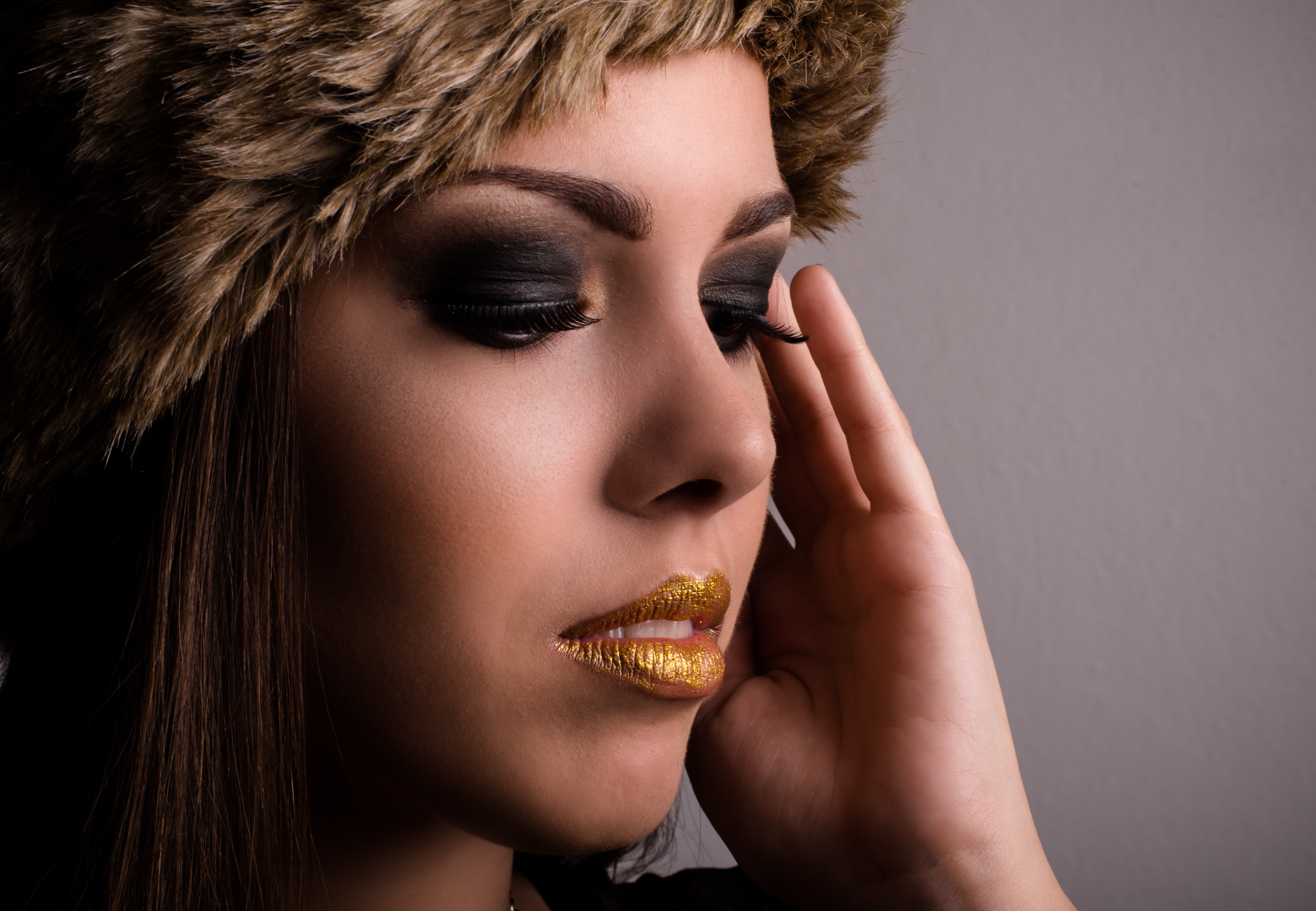 Woman with gold lips and fur hat HD Wallpaper