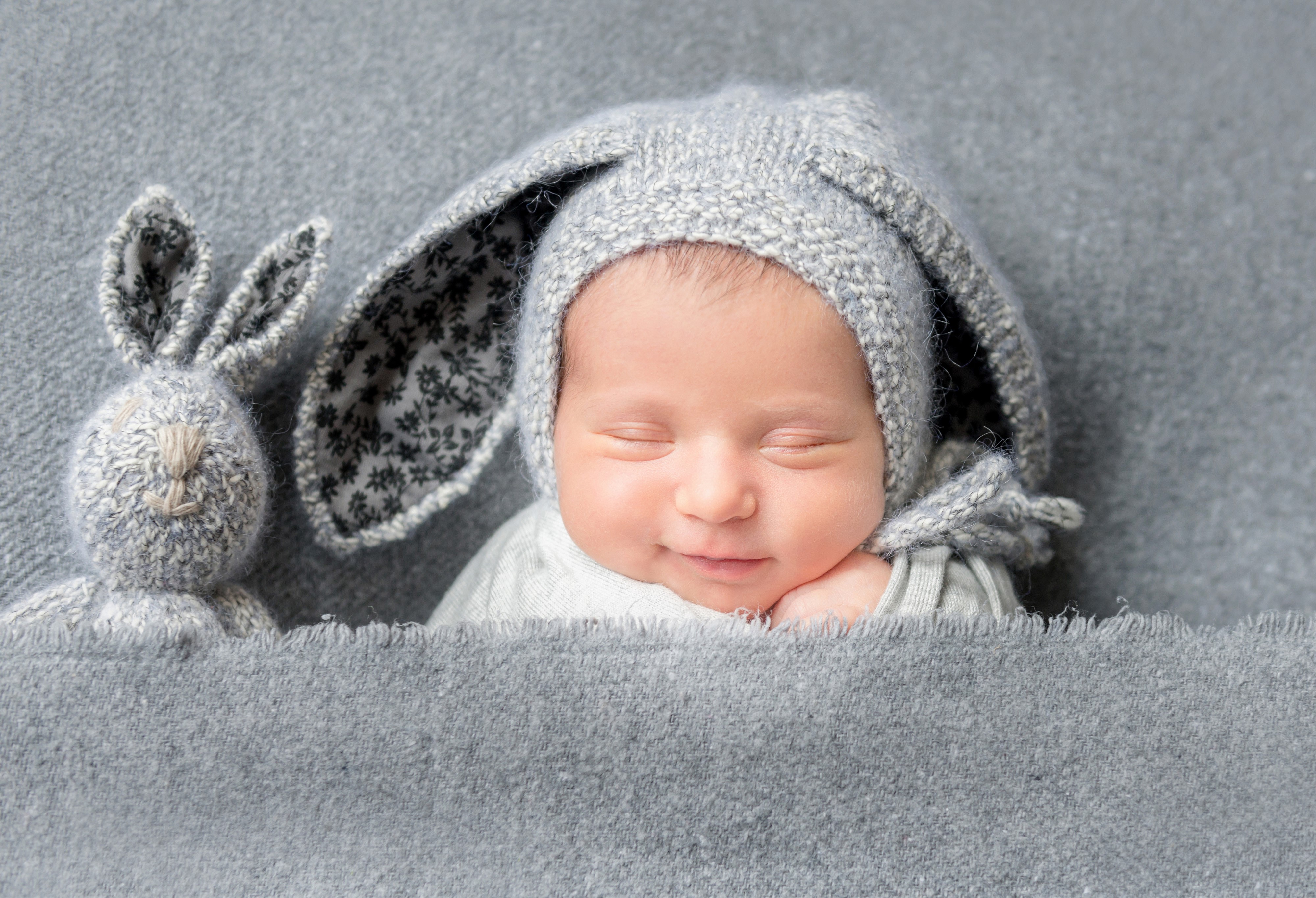 Baby in a bunny hat with a stuffed rabbit HD Wallpaper