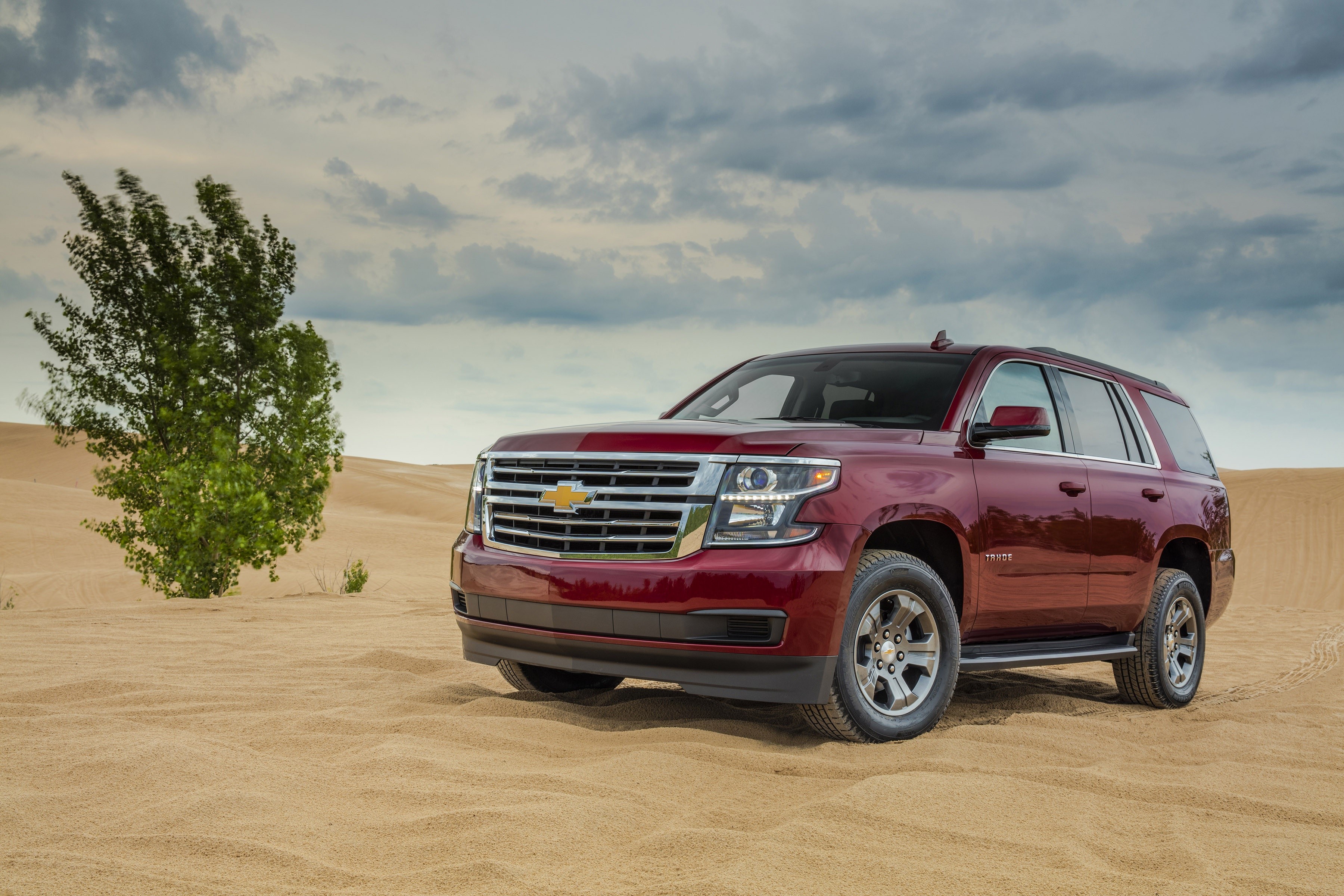 Red Chevrolet Tahoe SUV in a Sand Dune Landscape HD Wallpaper