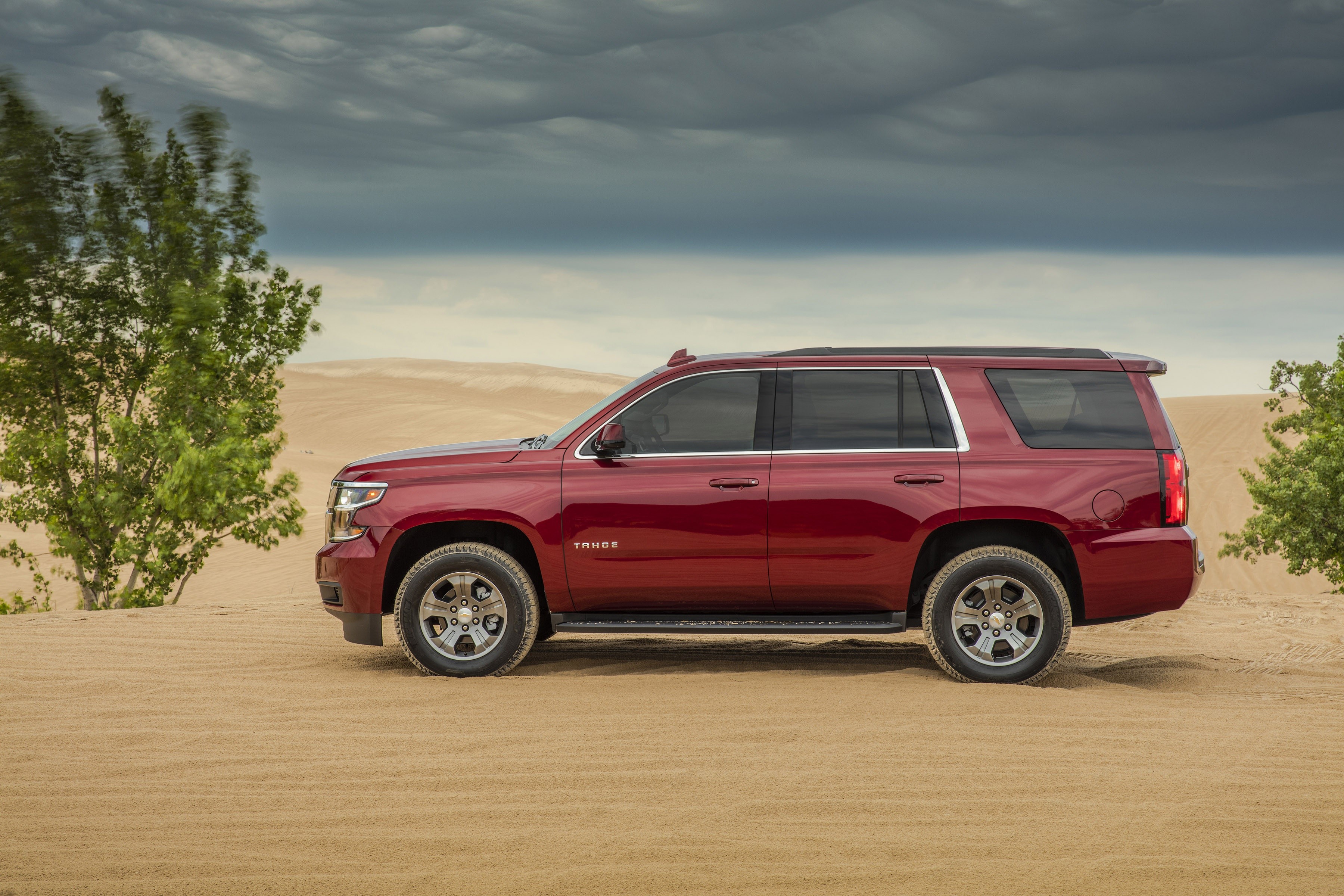 Red Chevrolet Tahoe SUV on sand dunes HD Wallpaper