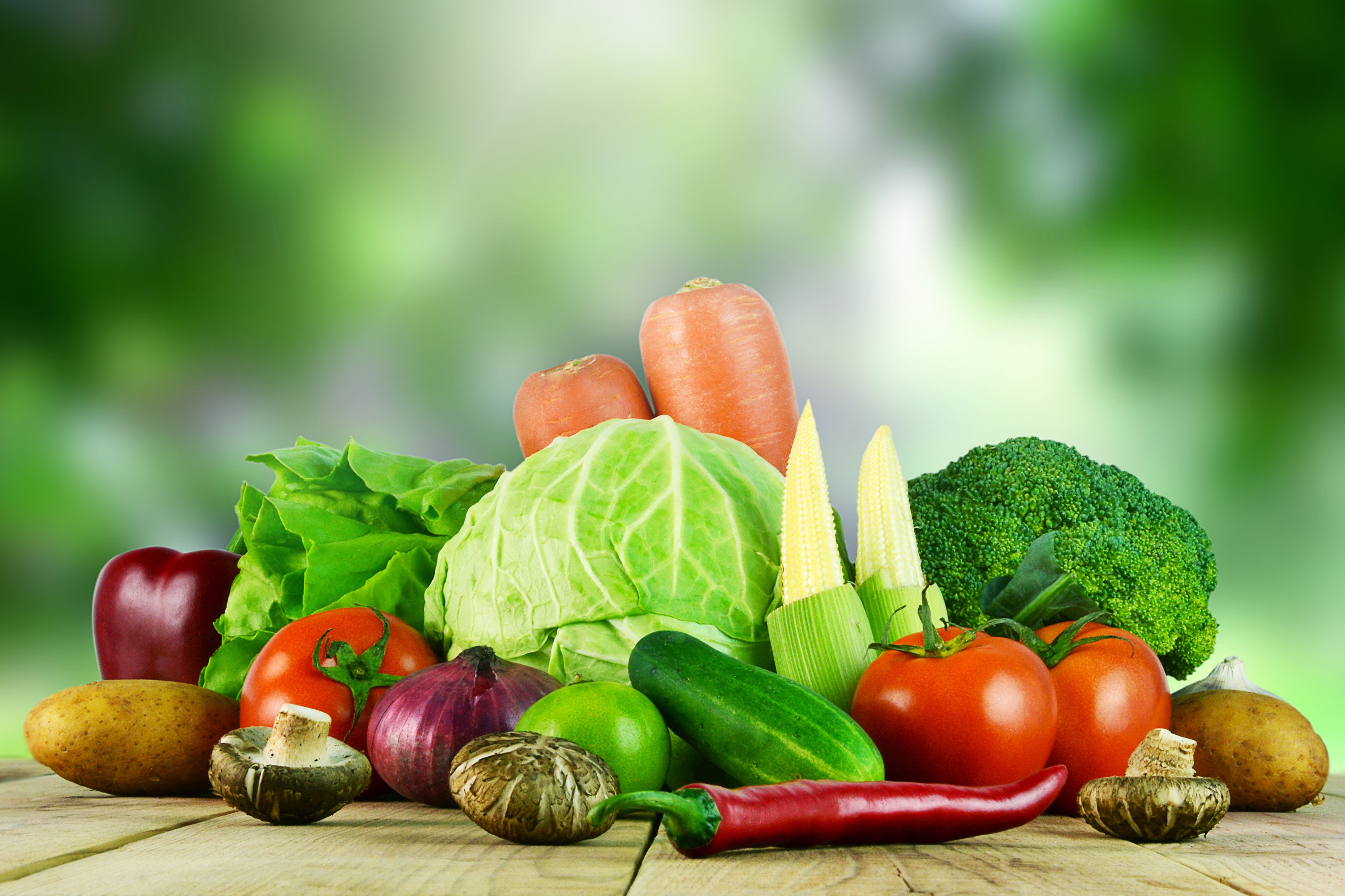 Assortment of fresh vegetables on a wooden table HD Wallpaper