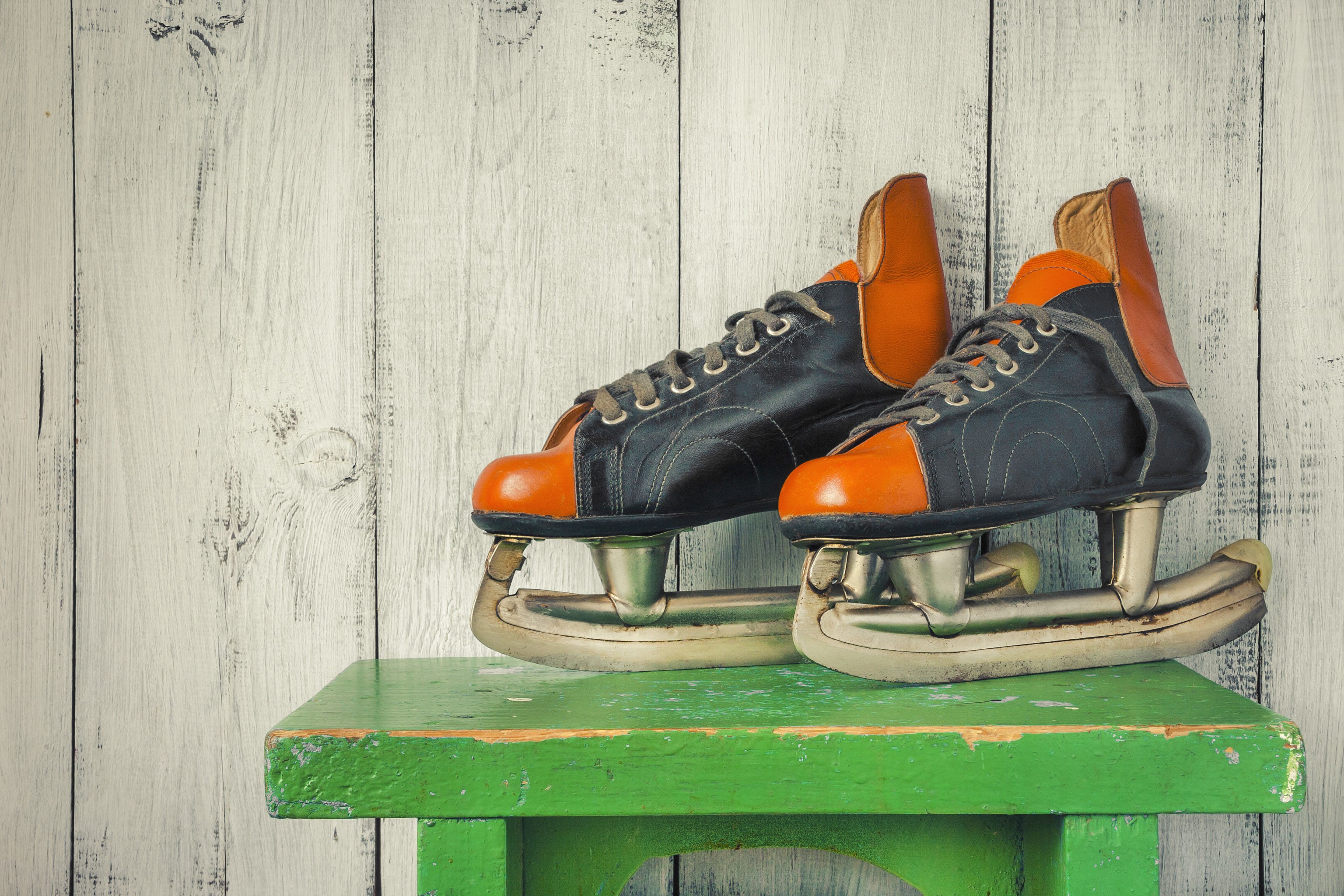 Vintage ice skates on a green stool HD Wallpaper