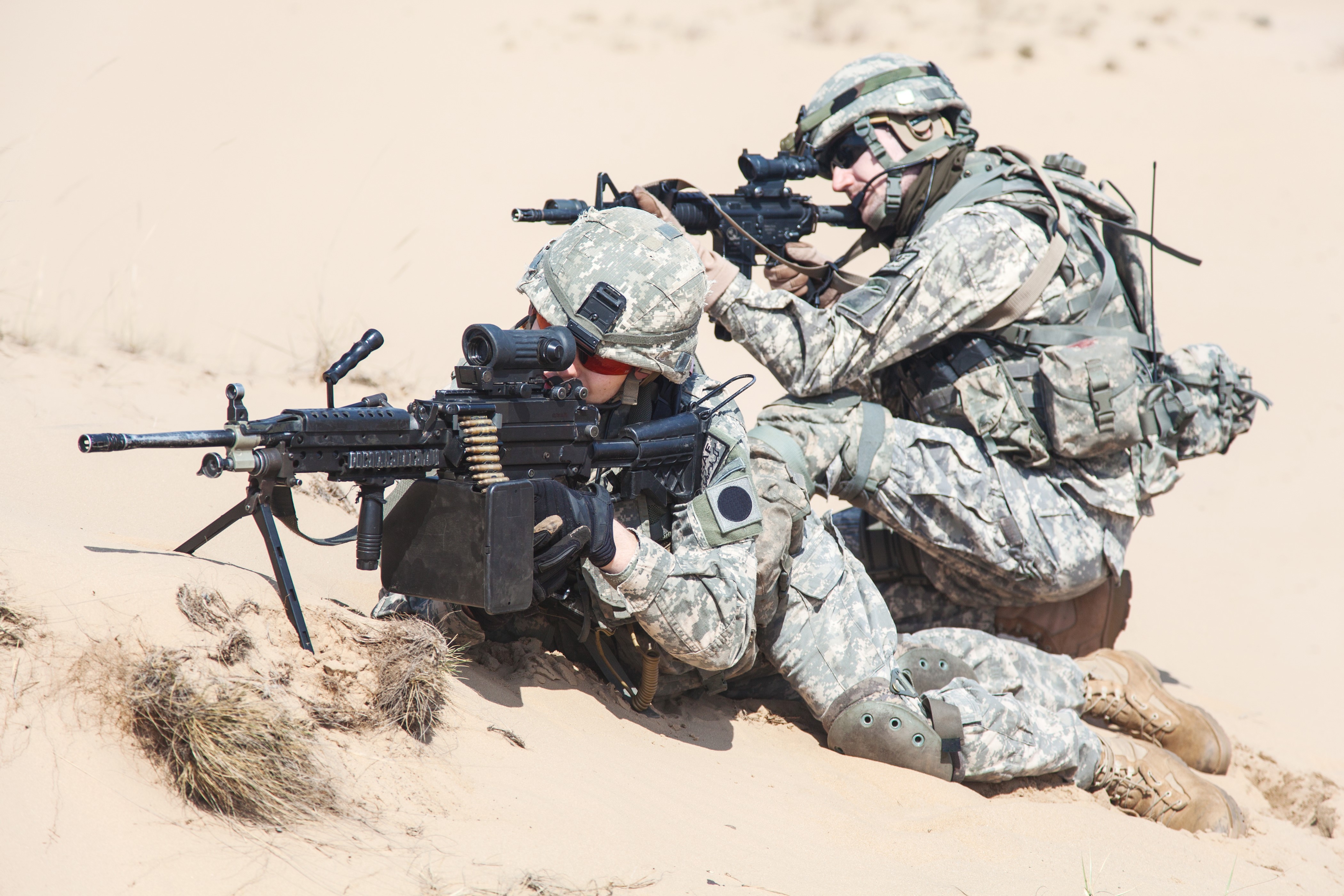 Two soldiers with assault rifles in desert HD Wallpaper