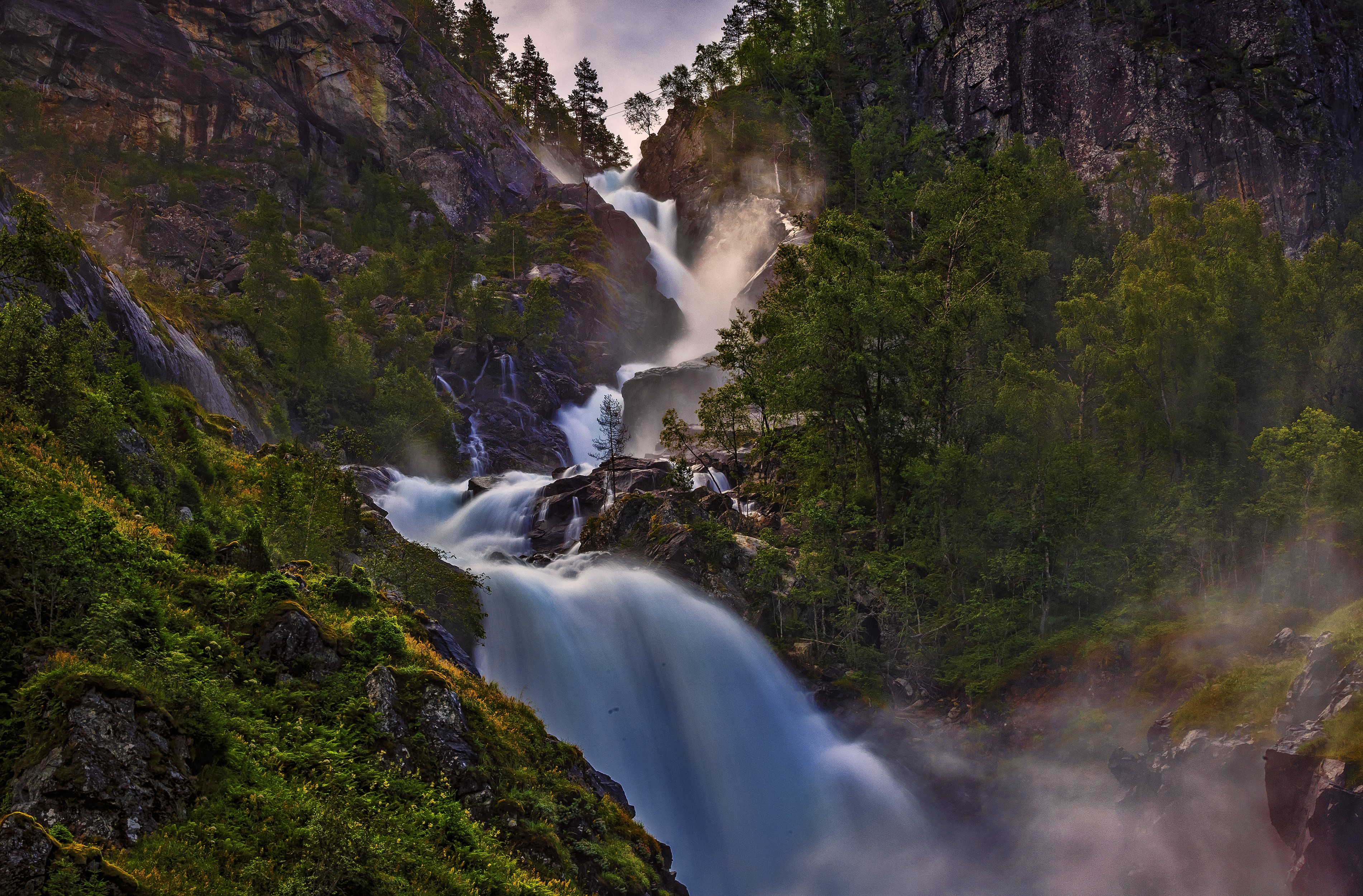 Waterfall cascading down a rocky mountainside in Norway HD Wallpaper