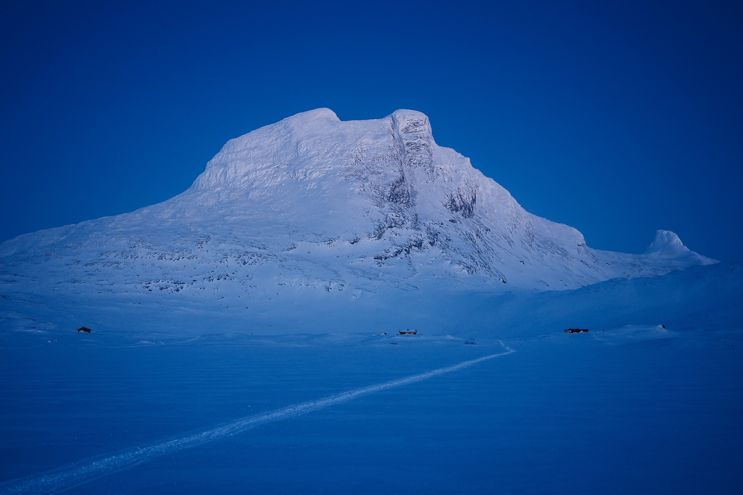 Snowy mountain landscape in Sulitjelma, Norway during winter evening HD Wallpaper
