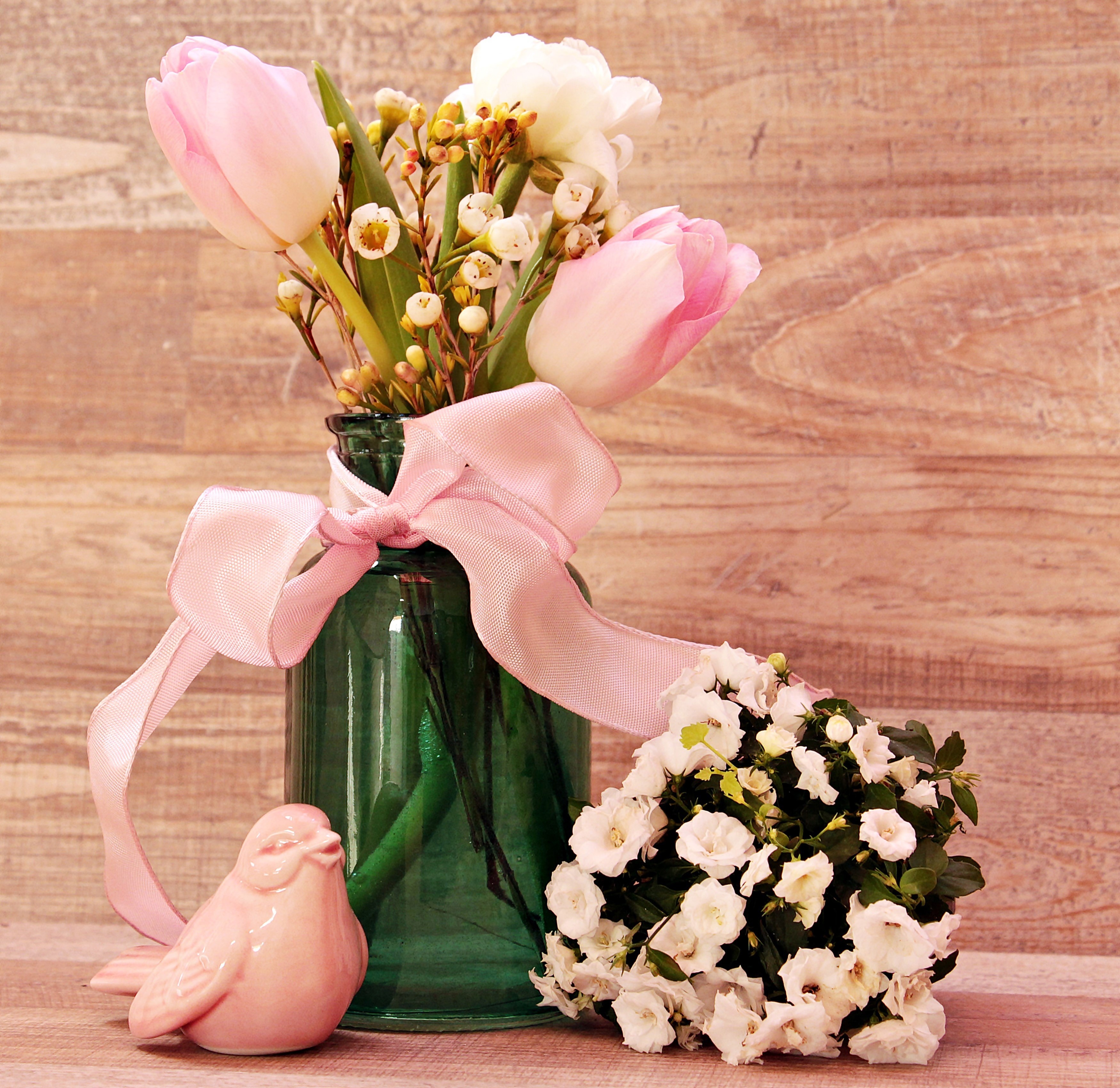 Pink tulips and white flowers in a green vase with a pink ribbon and a pink bird figurine HD Wallpaper