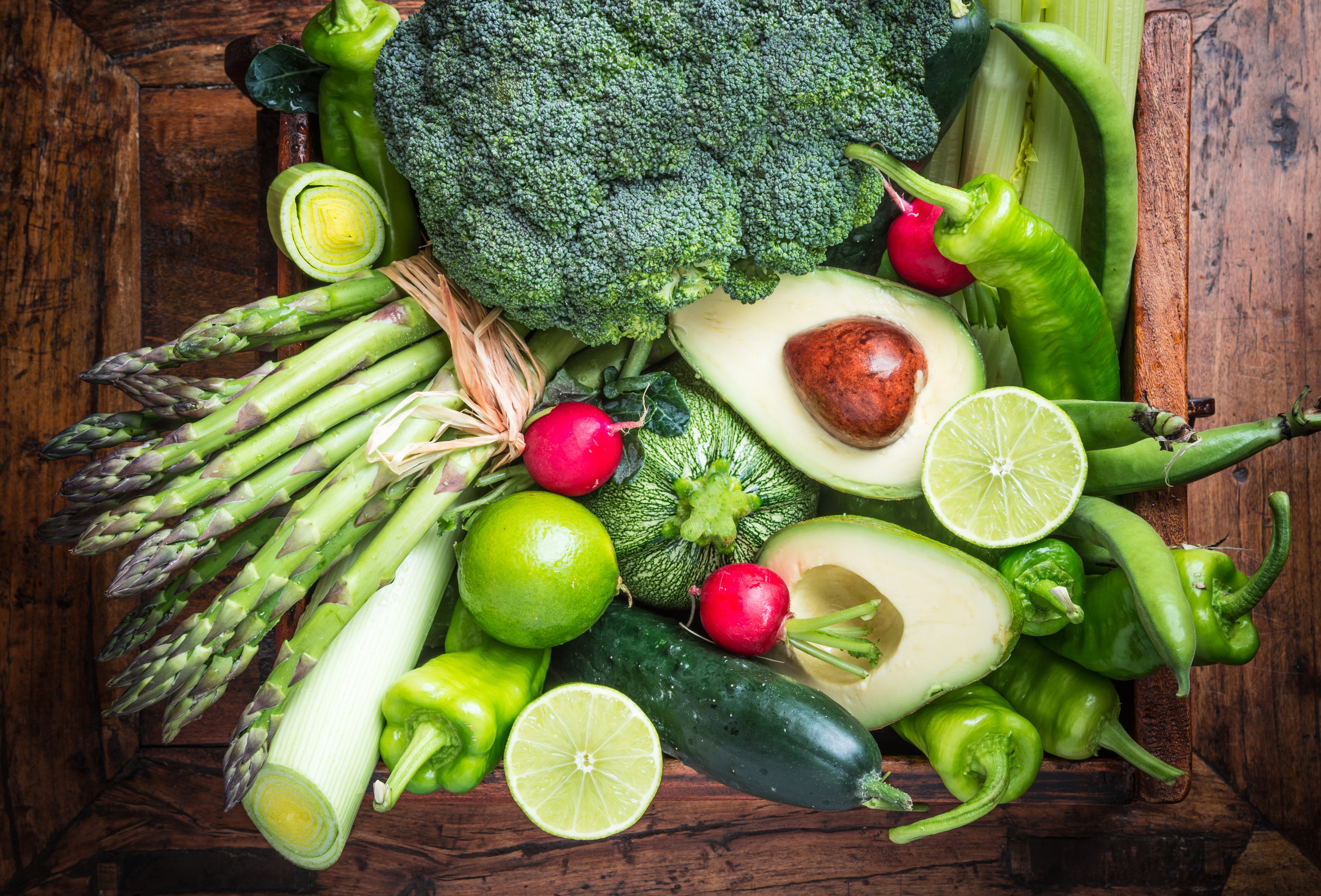 Assortment of fresh green vegetables and fruits on wood HD Wallpaper