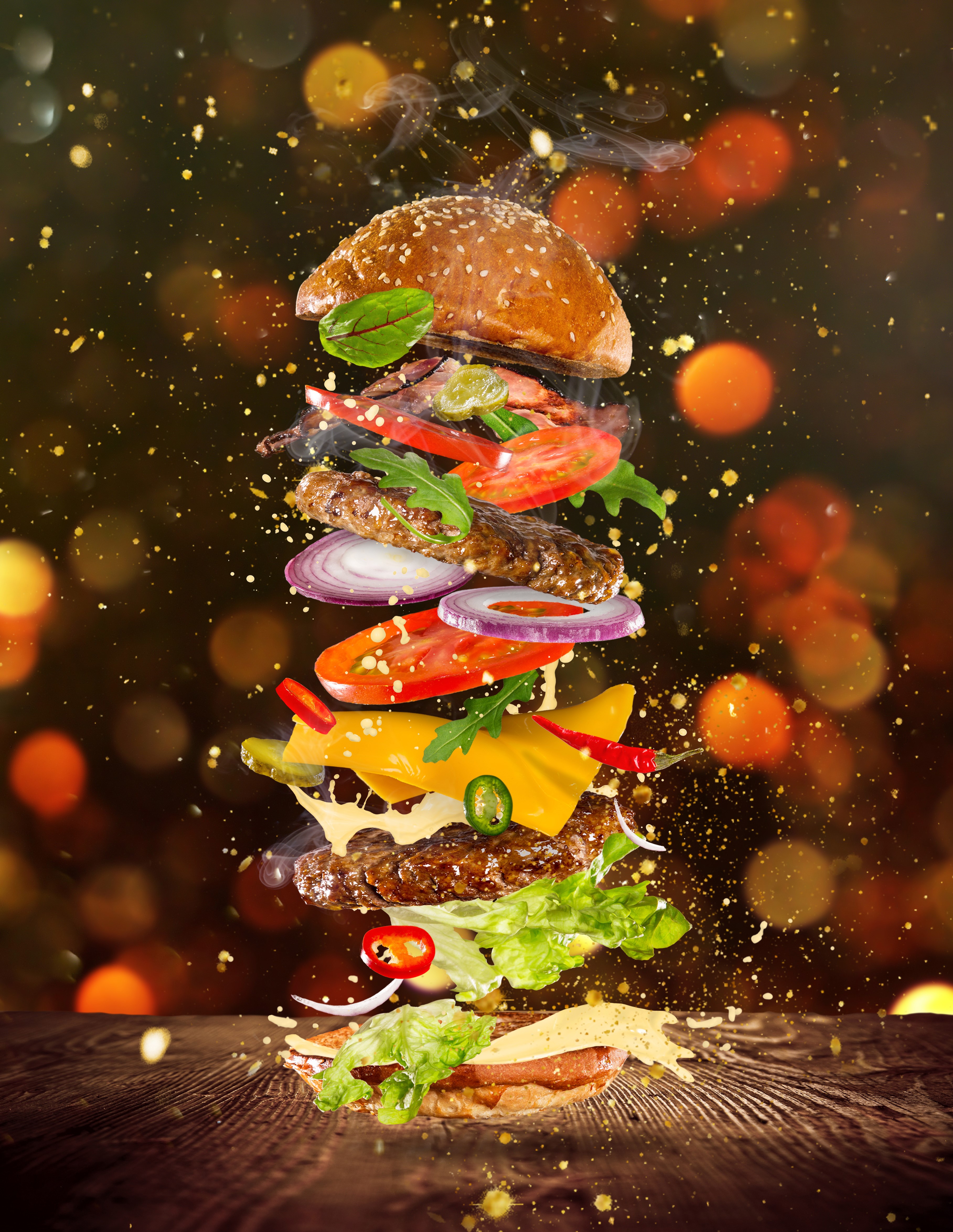 Exploded view of a gourmet hamburger with ingredients suspended in air HD Phone Wallpaper