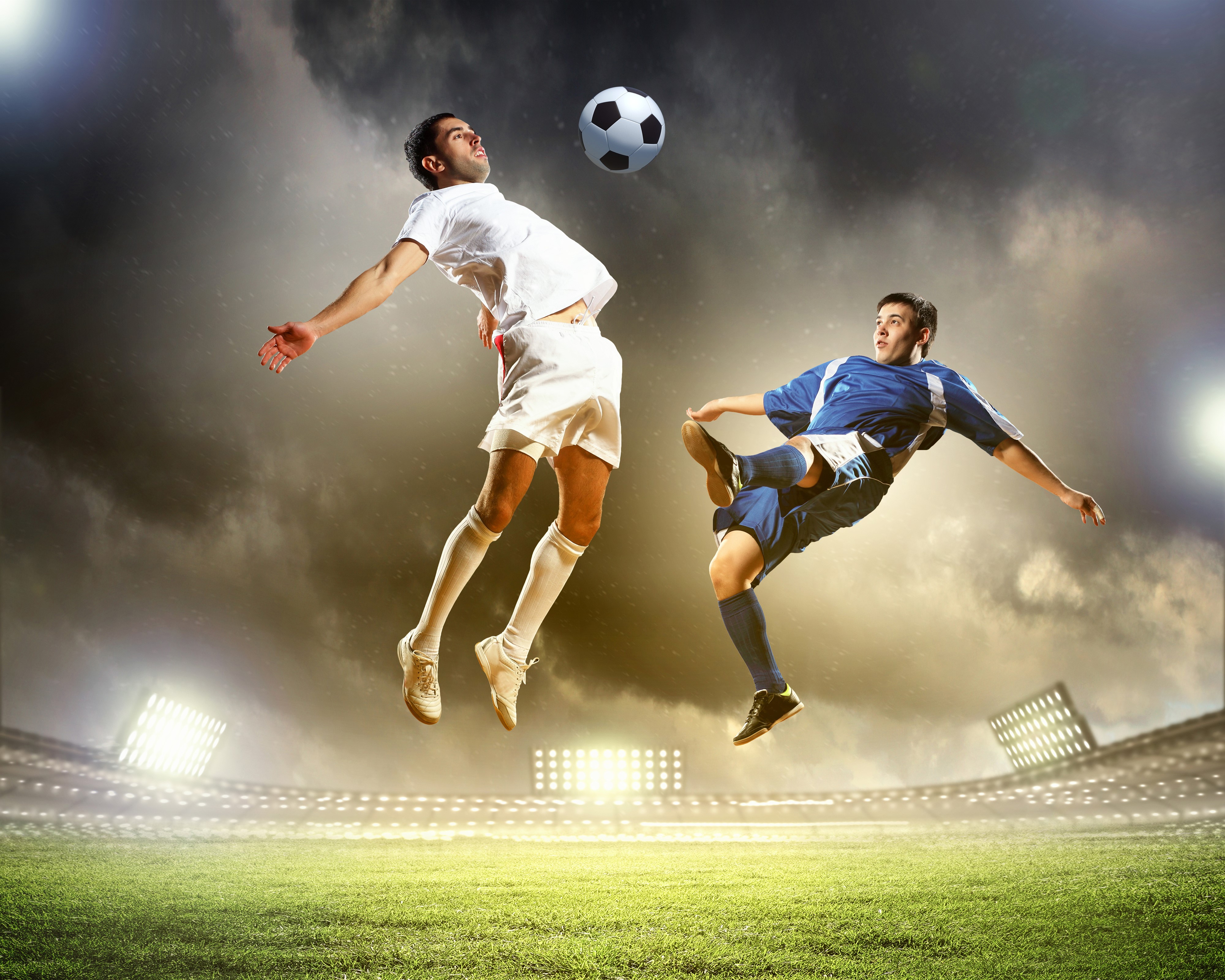 Two men jumping for a soccer ball HD Wallpaper