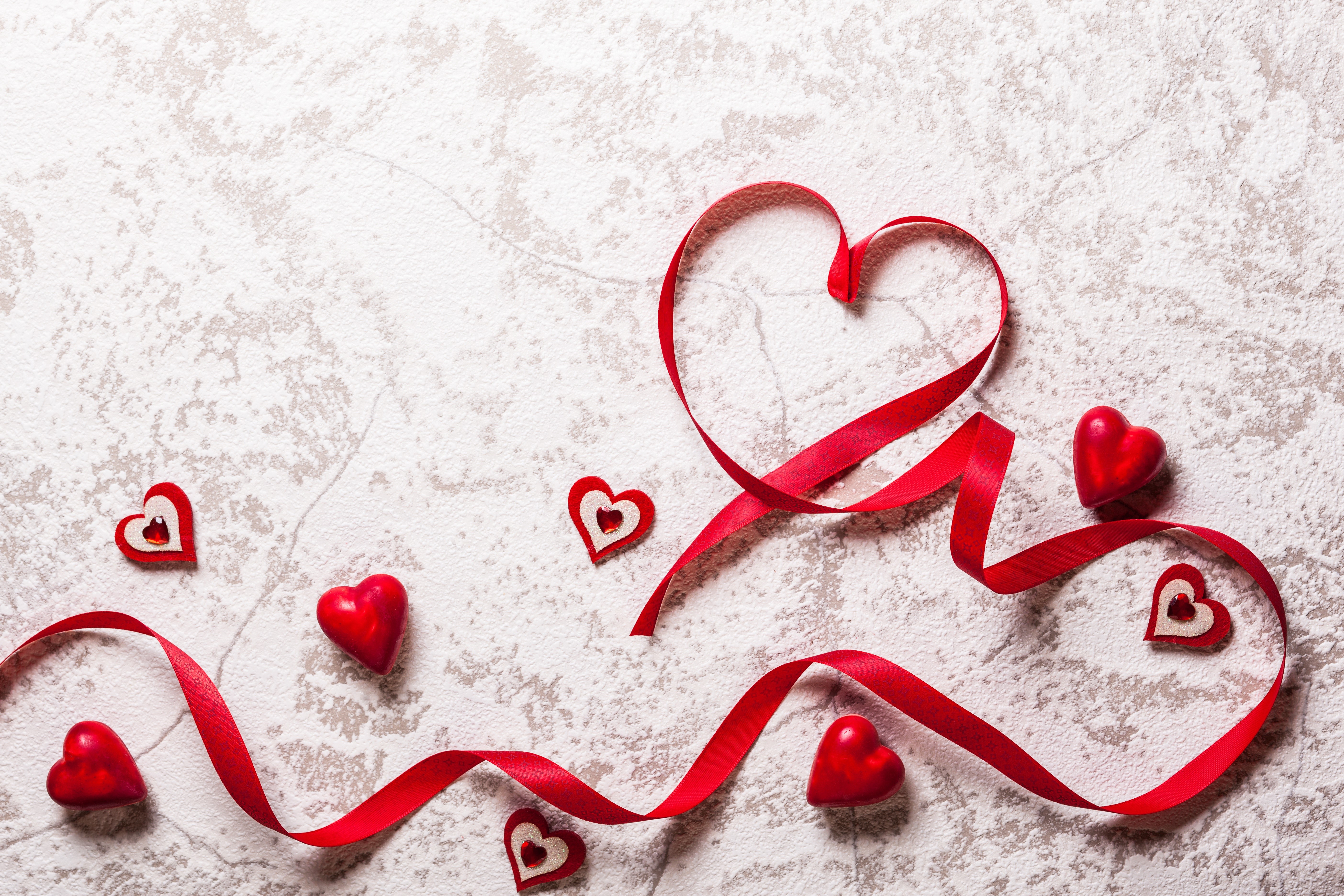 Red ribbon and hearts on a textured background HD Wallpaper