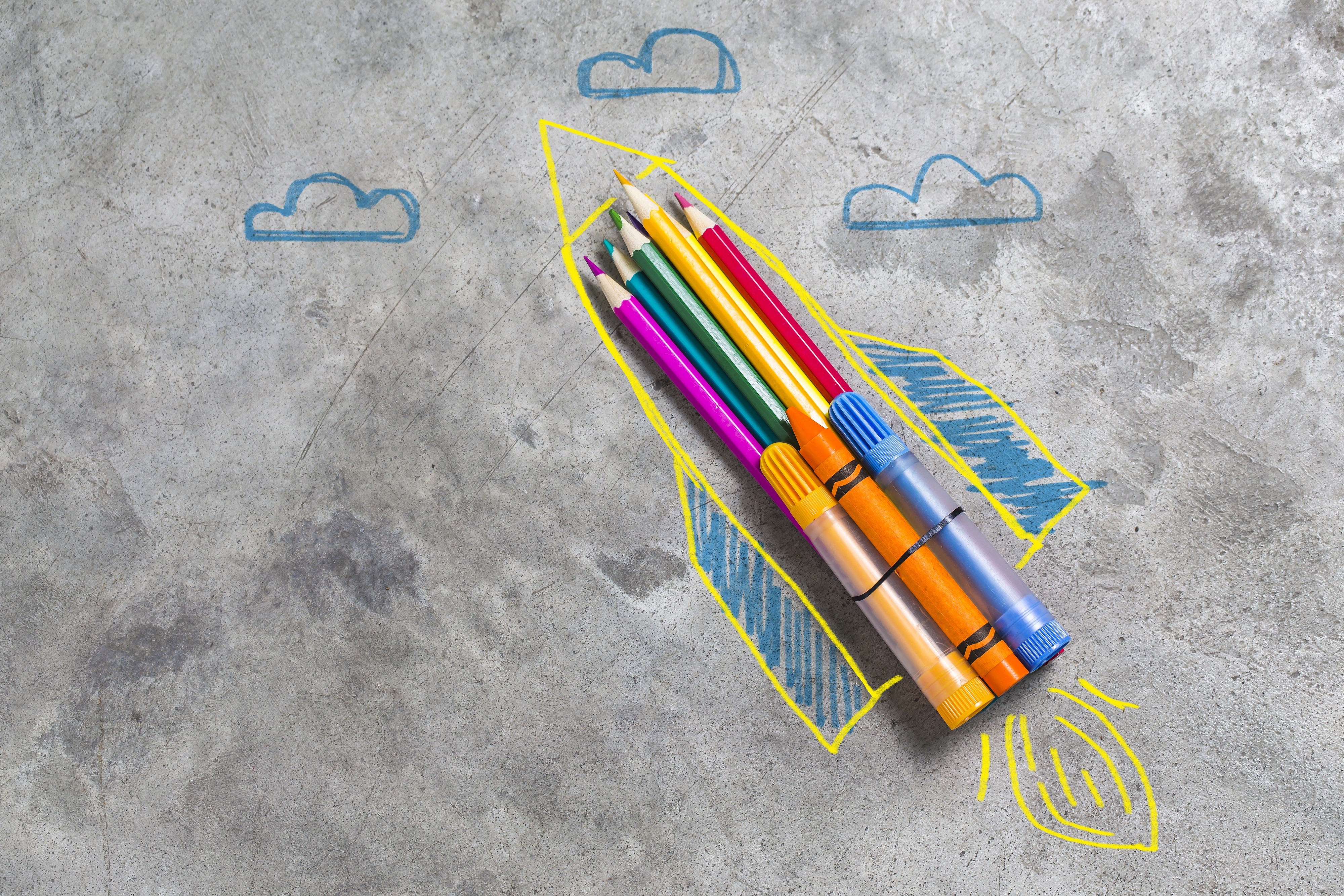 Rocket drawn with pencils and markers on concrete HD Wallpaper