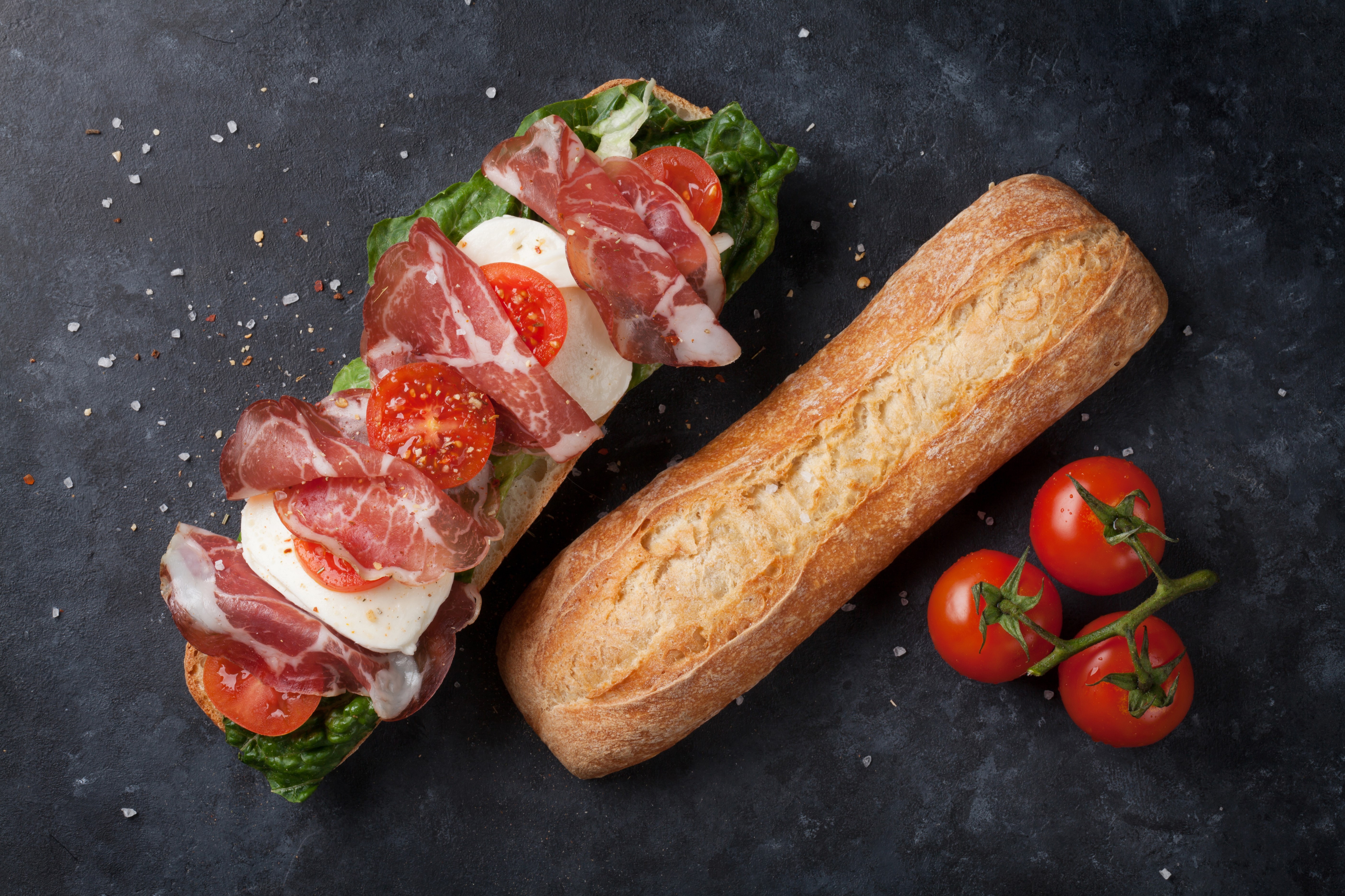 Sandwich with ham, mozzarella, tomatoes, and lettuce on a baguette HD Wallpaper