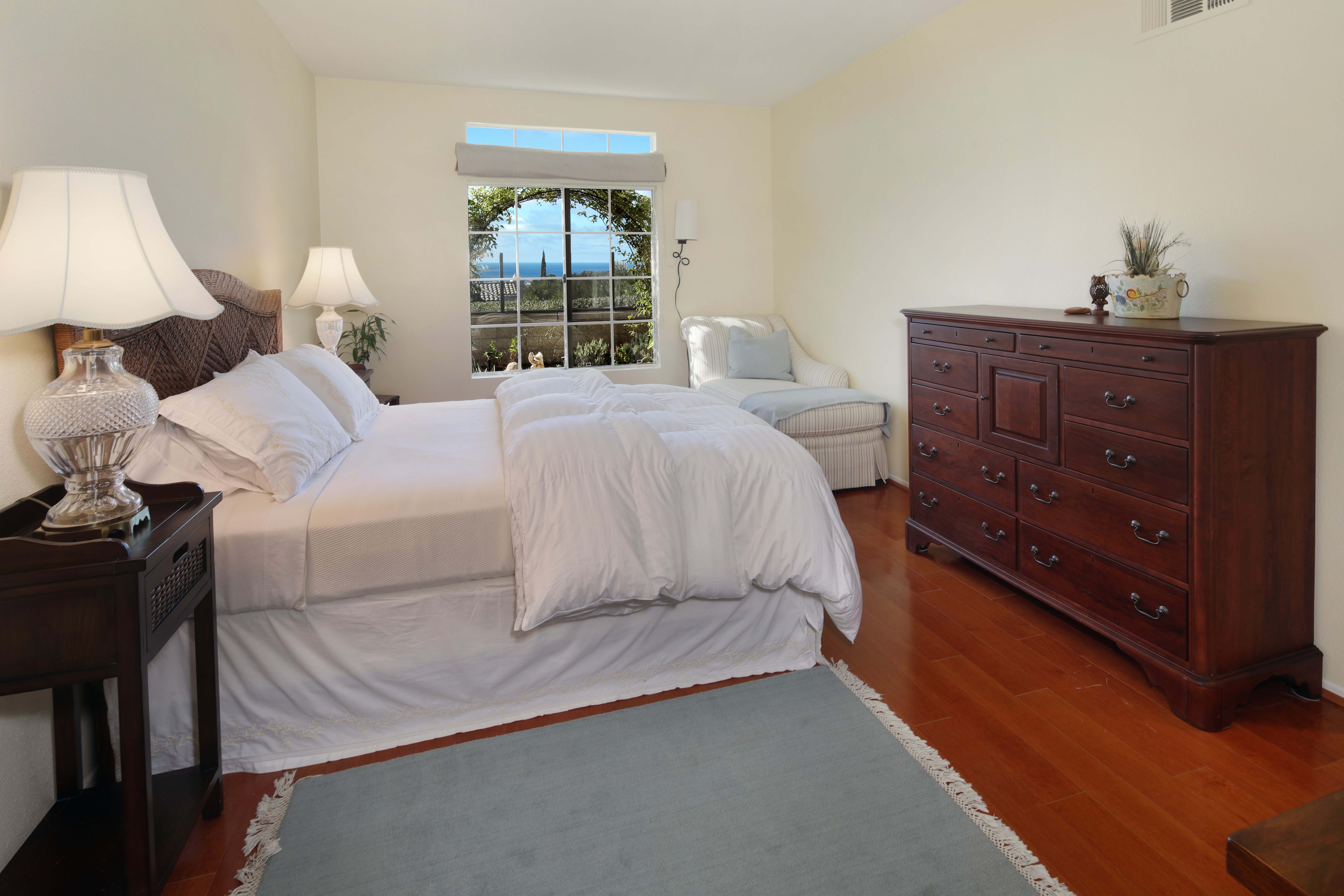 Bedroom with bed, dresser, and window view HD Wallpaper