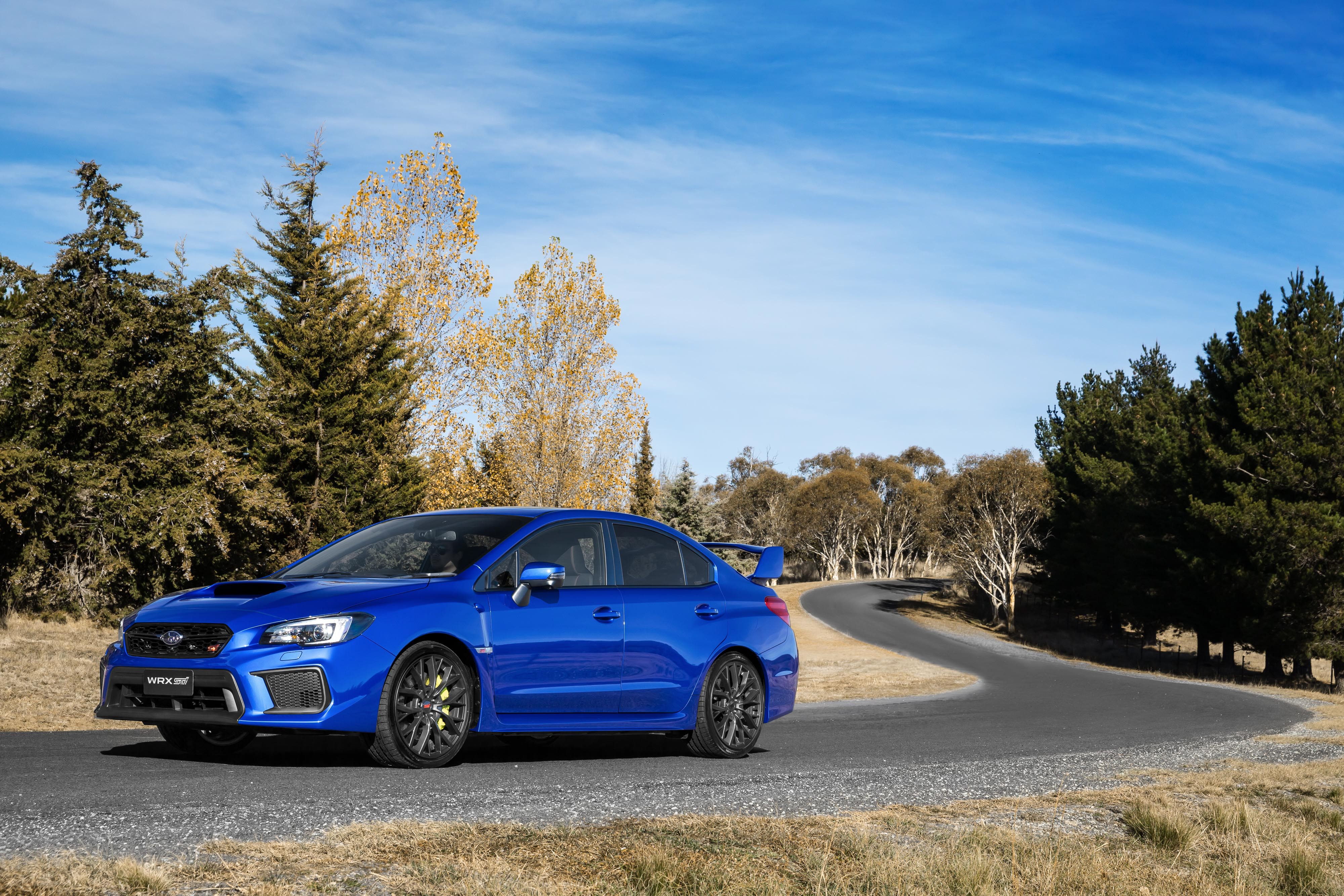 Blue 2017 Subaru WRX STI on a winding road HD Wallpaper