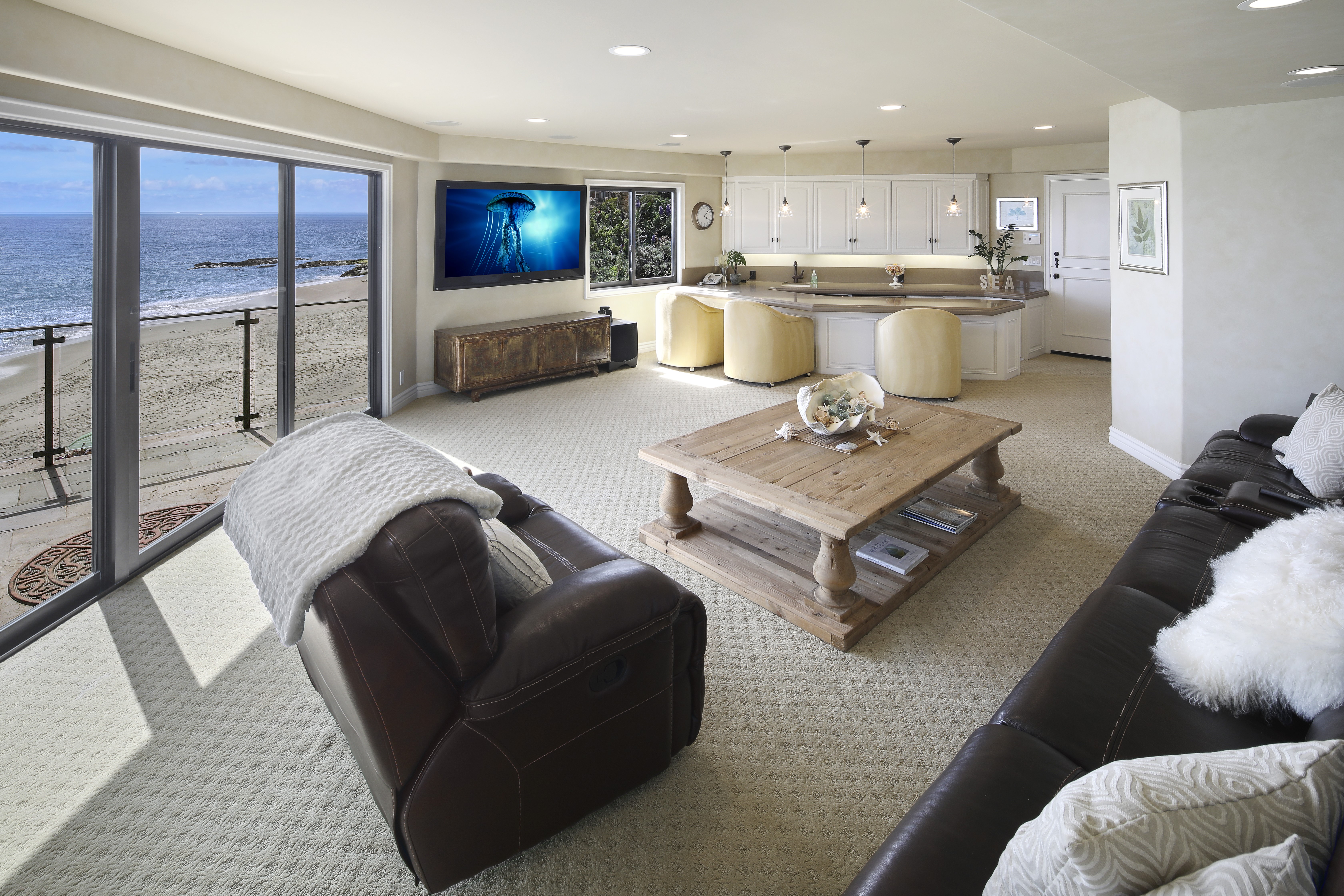 Living room with ocean view and kitchen HD Wallpaper