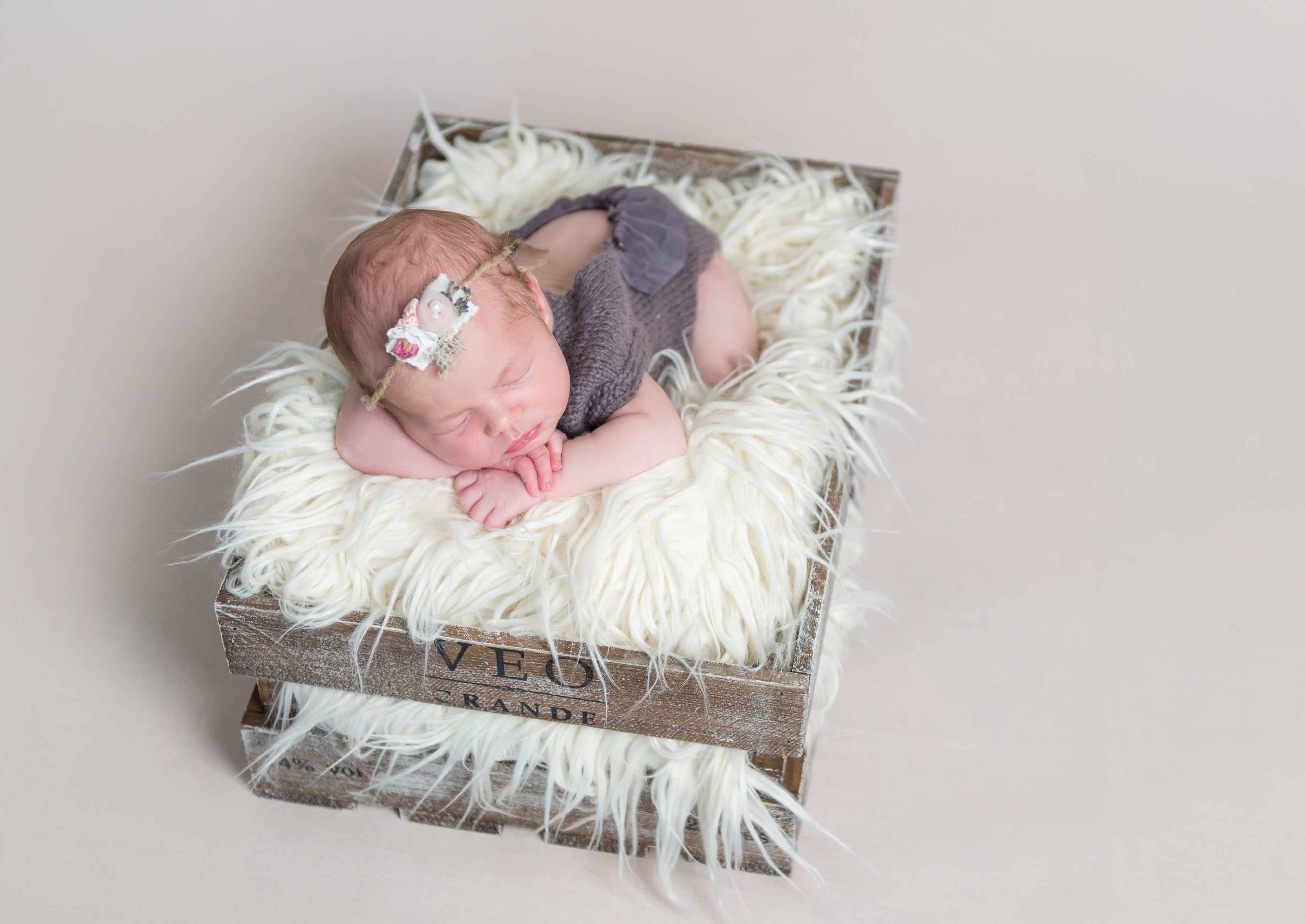 Newborn baby sleeping in a wooden crate HD Wallpaper