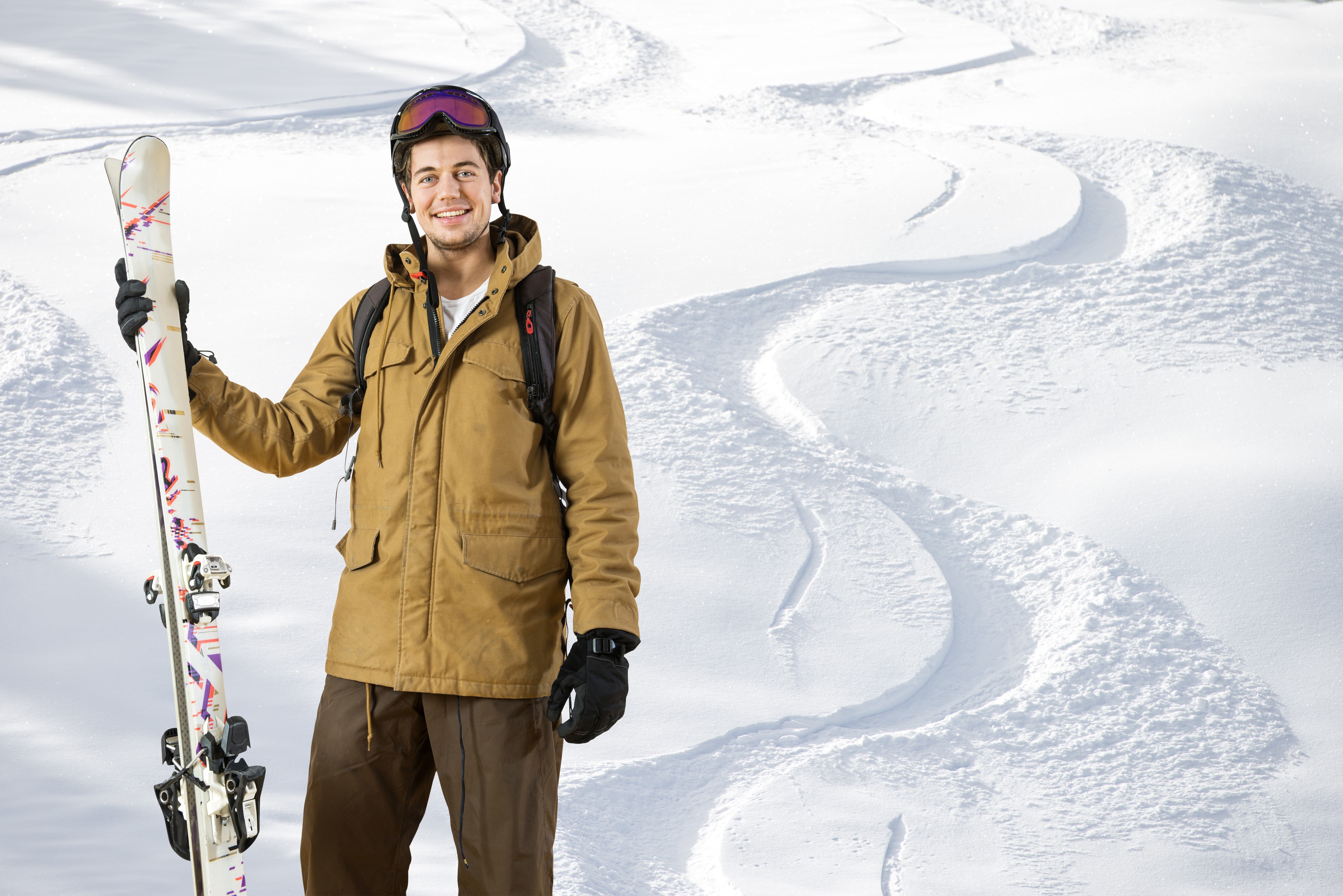 Man with skis on a snowy slope HD Wallpaper