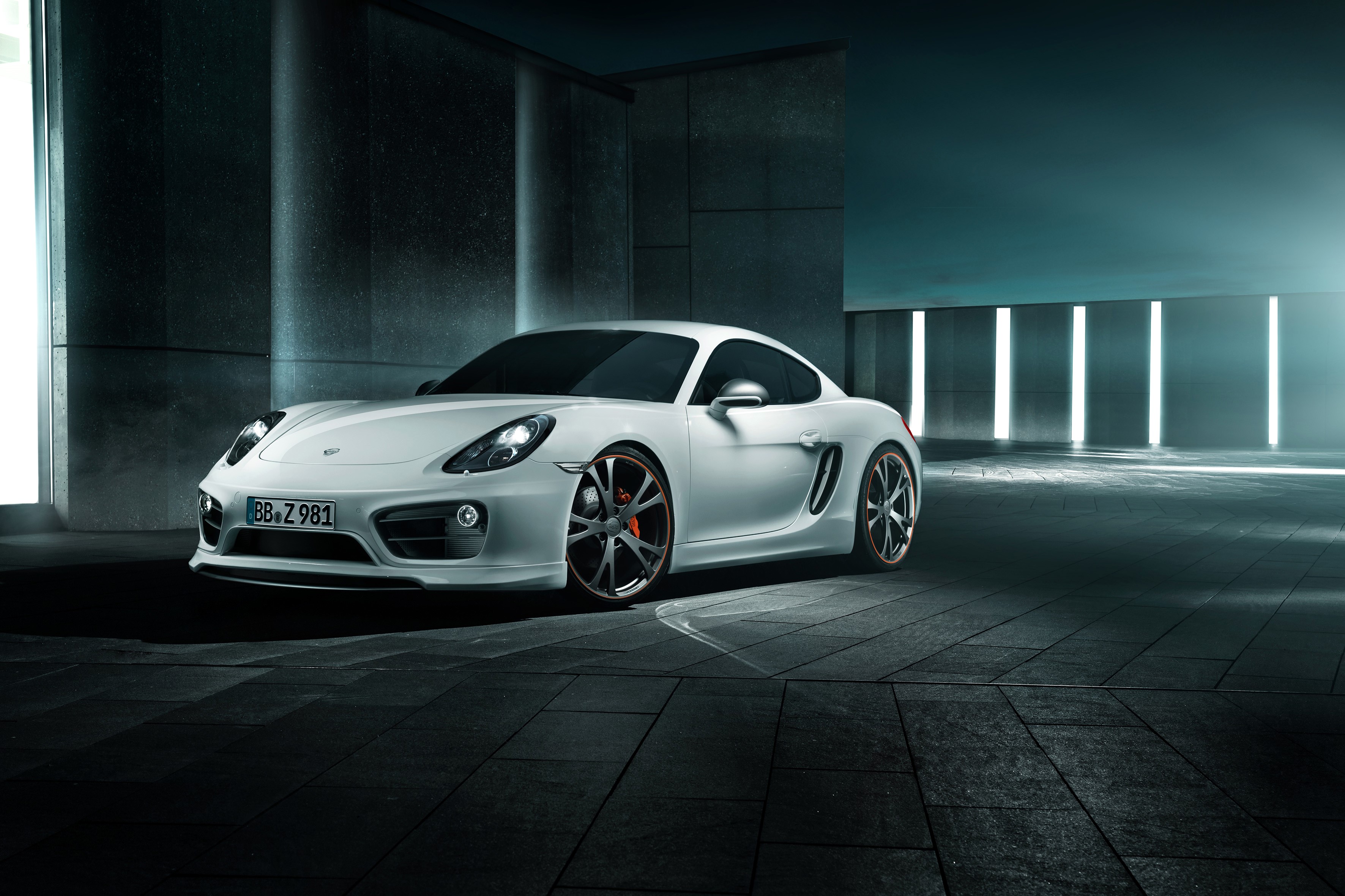 White TechArt Porsche Cayman parked in modern architecture HD Wallpaper