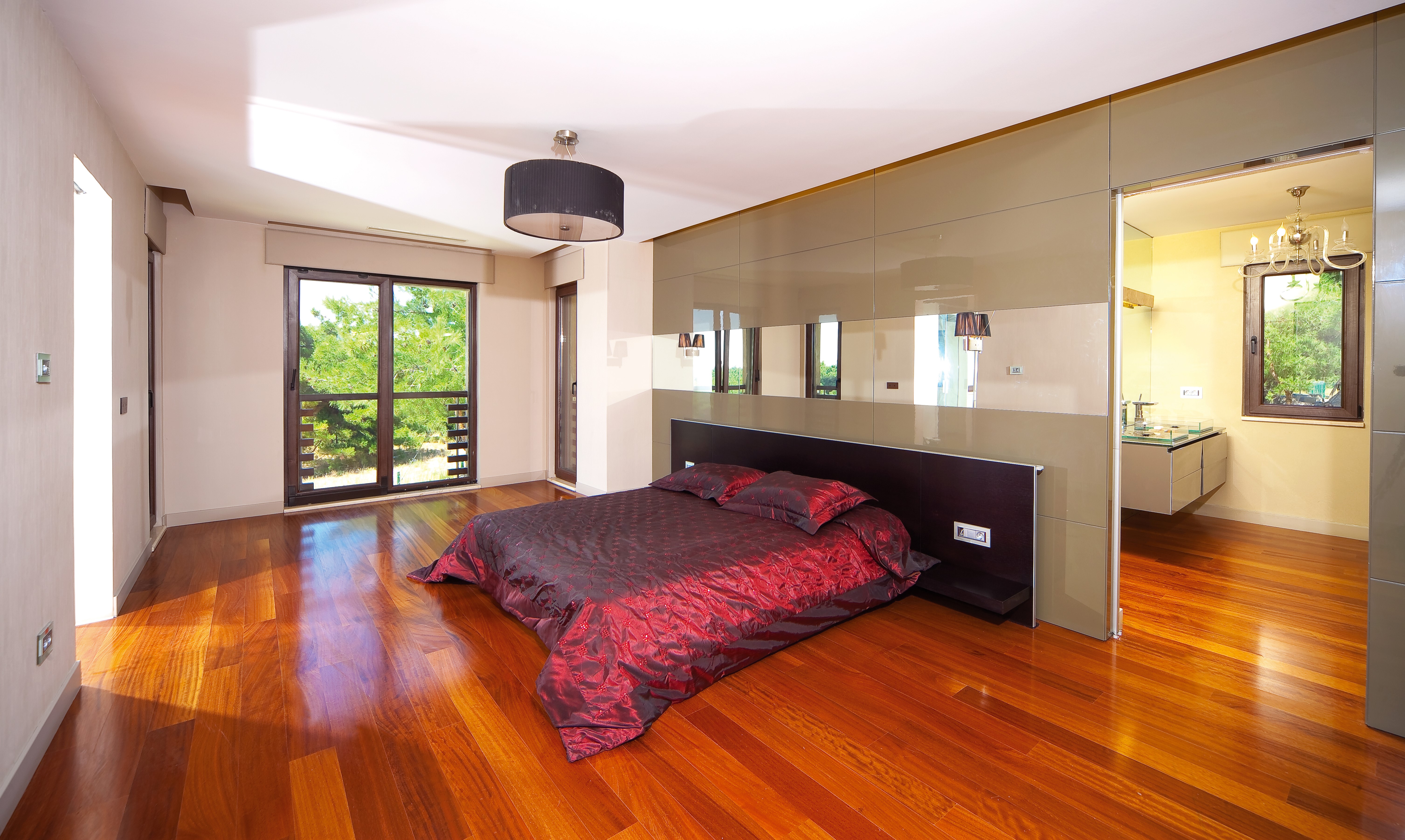 Modern Bedroom with Red Bed and Ensuite Bathroom HD Wallpaper