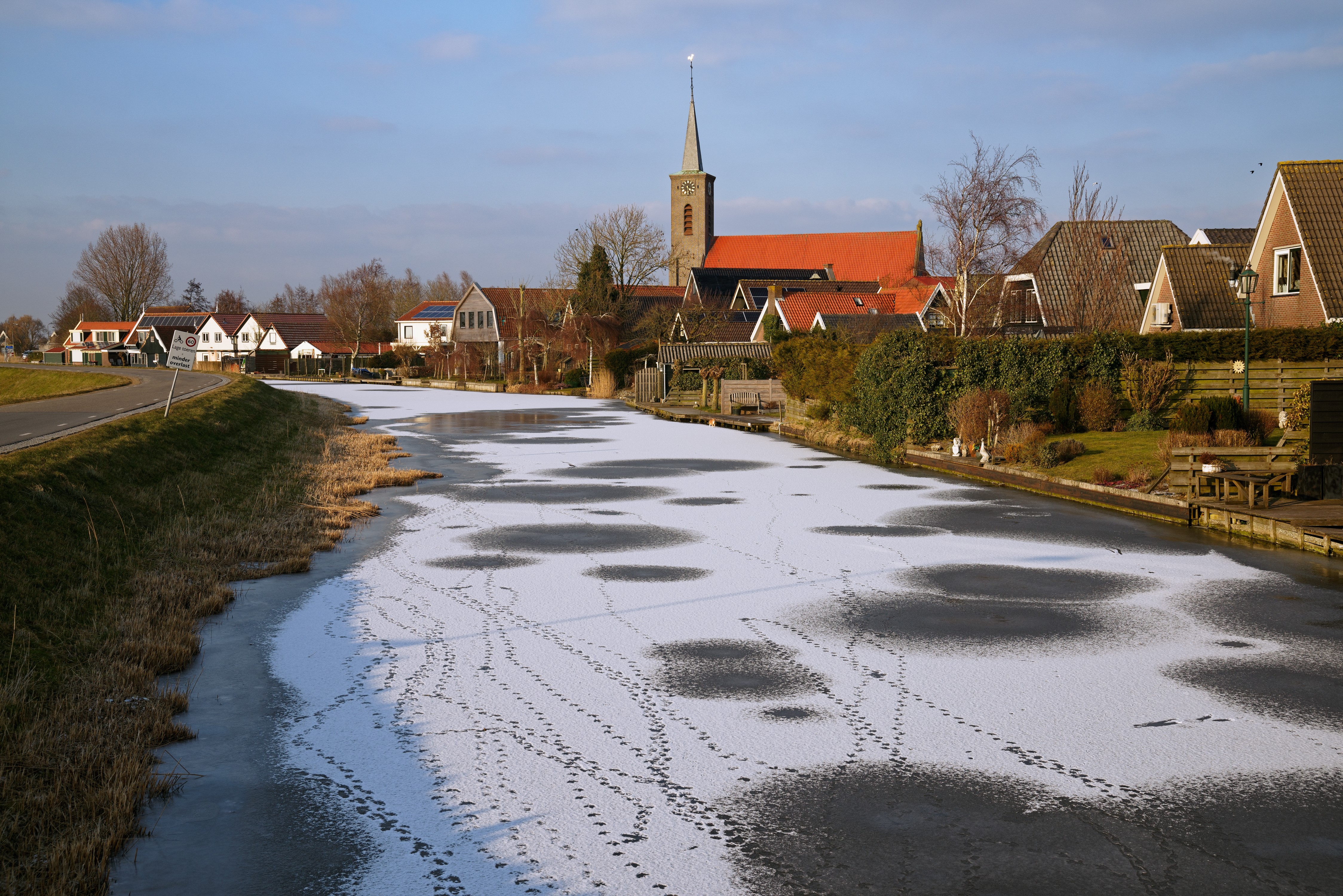 Winter scene in Schermer, Netherlands with frozen canal and houses HD Wallpaper