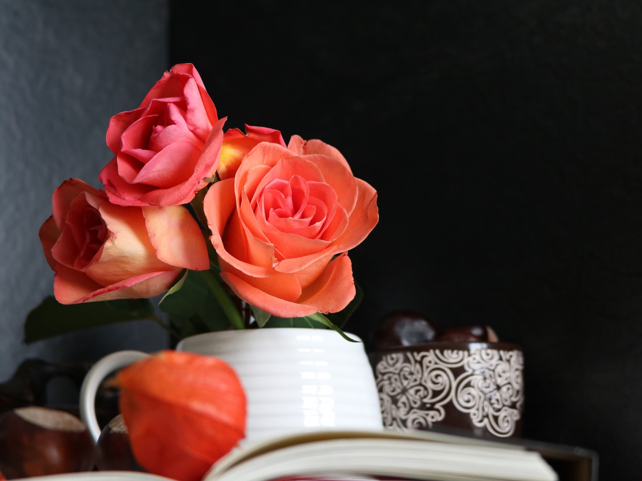 Roses in a vase with a book and chestnuts HD Wallpaper