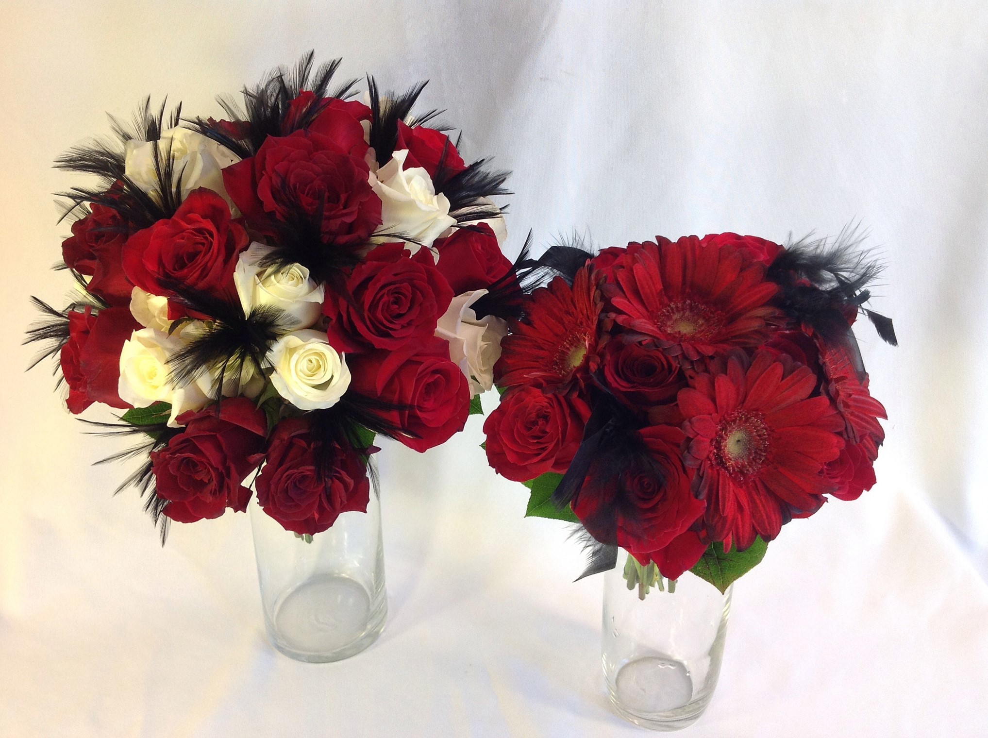 Two bouquets of red and white roses with black feathers HD Wallpaper