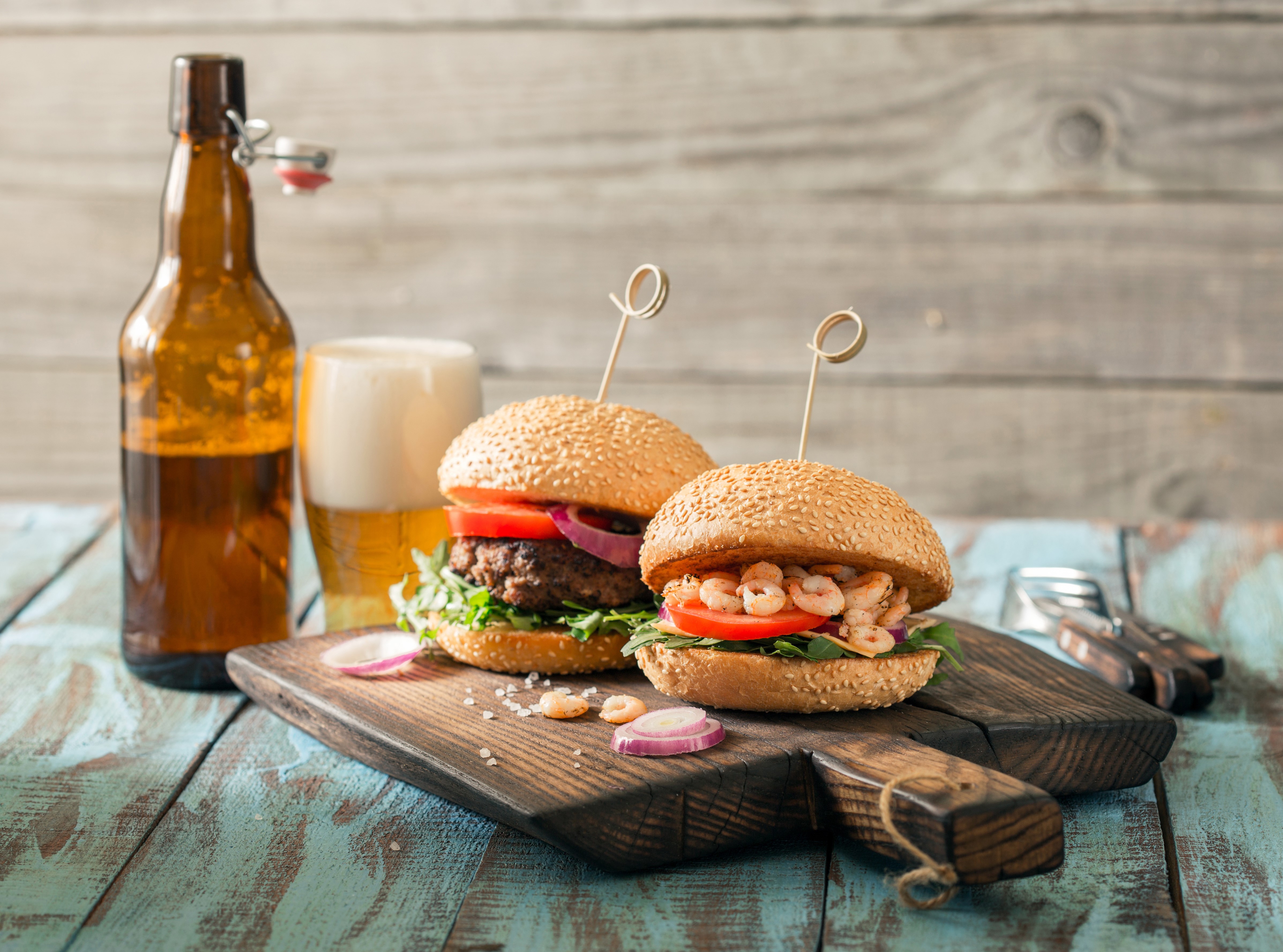 Two gourmet burgers and a beer bottle HD Wallpaper
