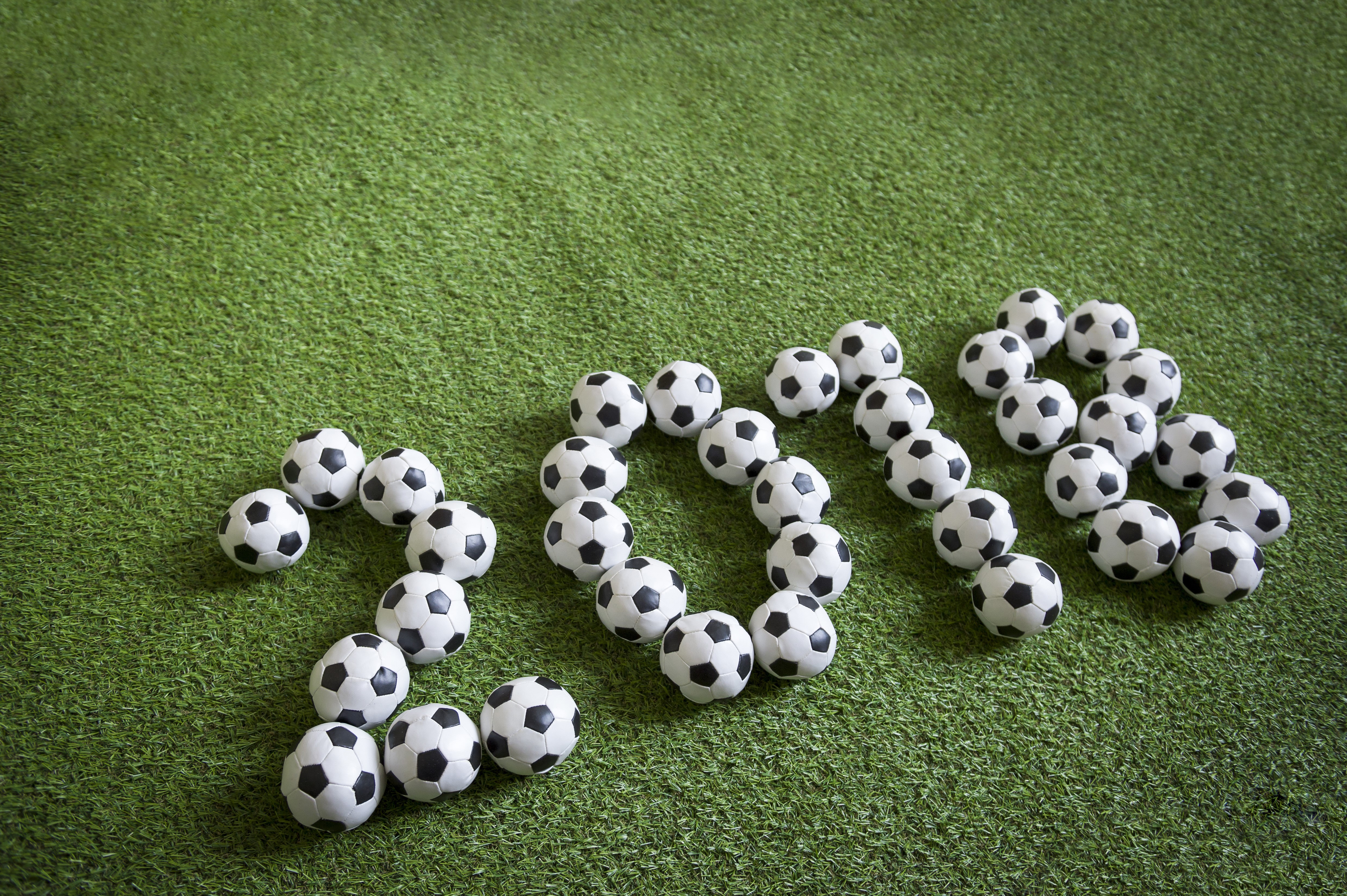 Soccer balls forming the year 2018 on grass HD Wallpaper