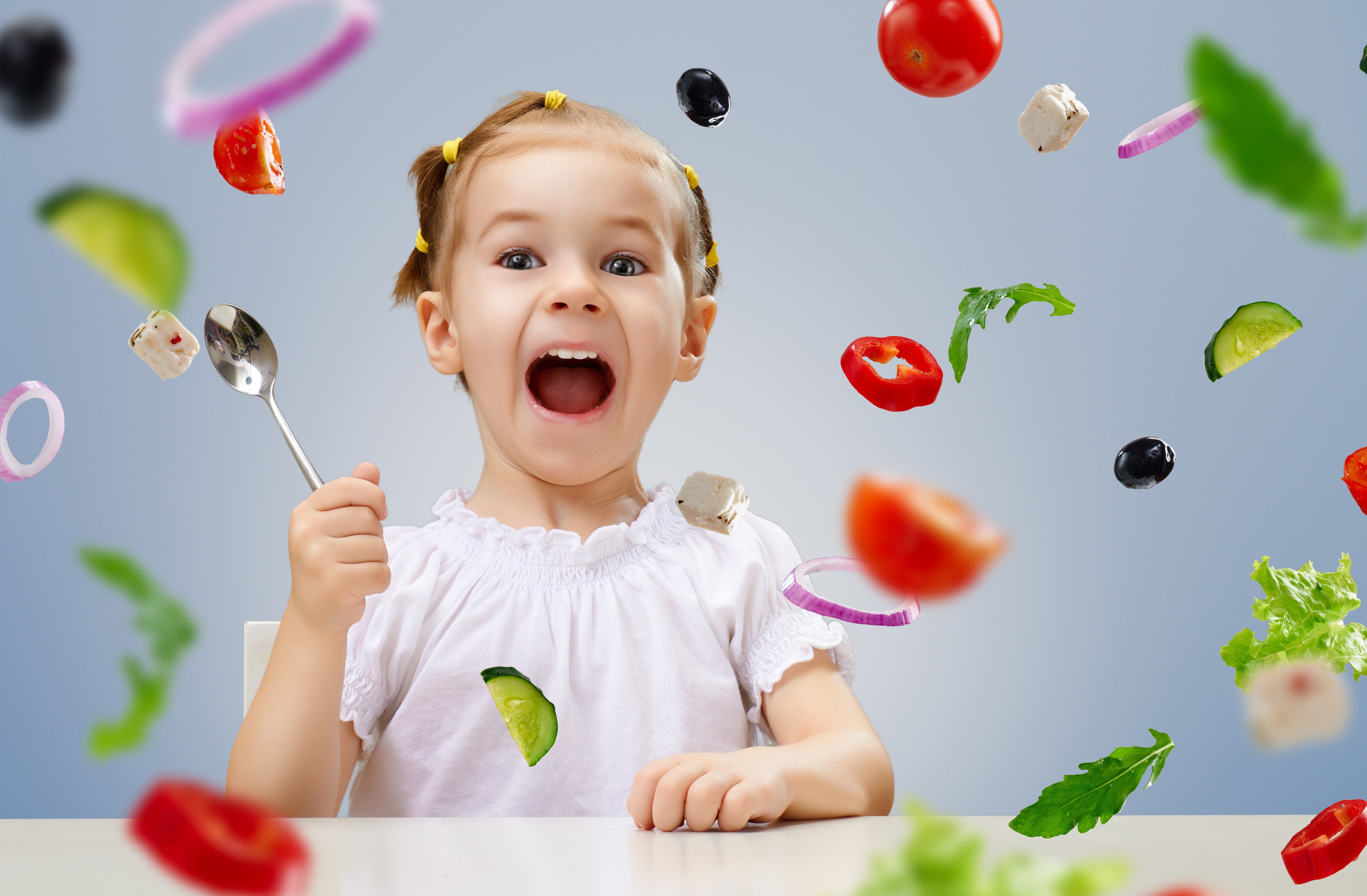 Little girl with flying vegetables and spoon HD Wallpaper