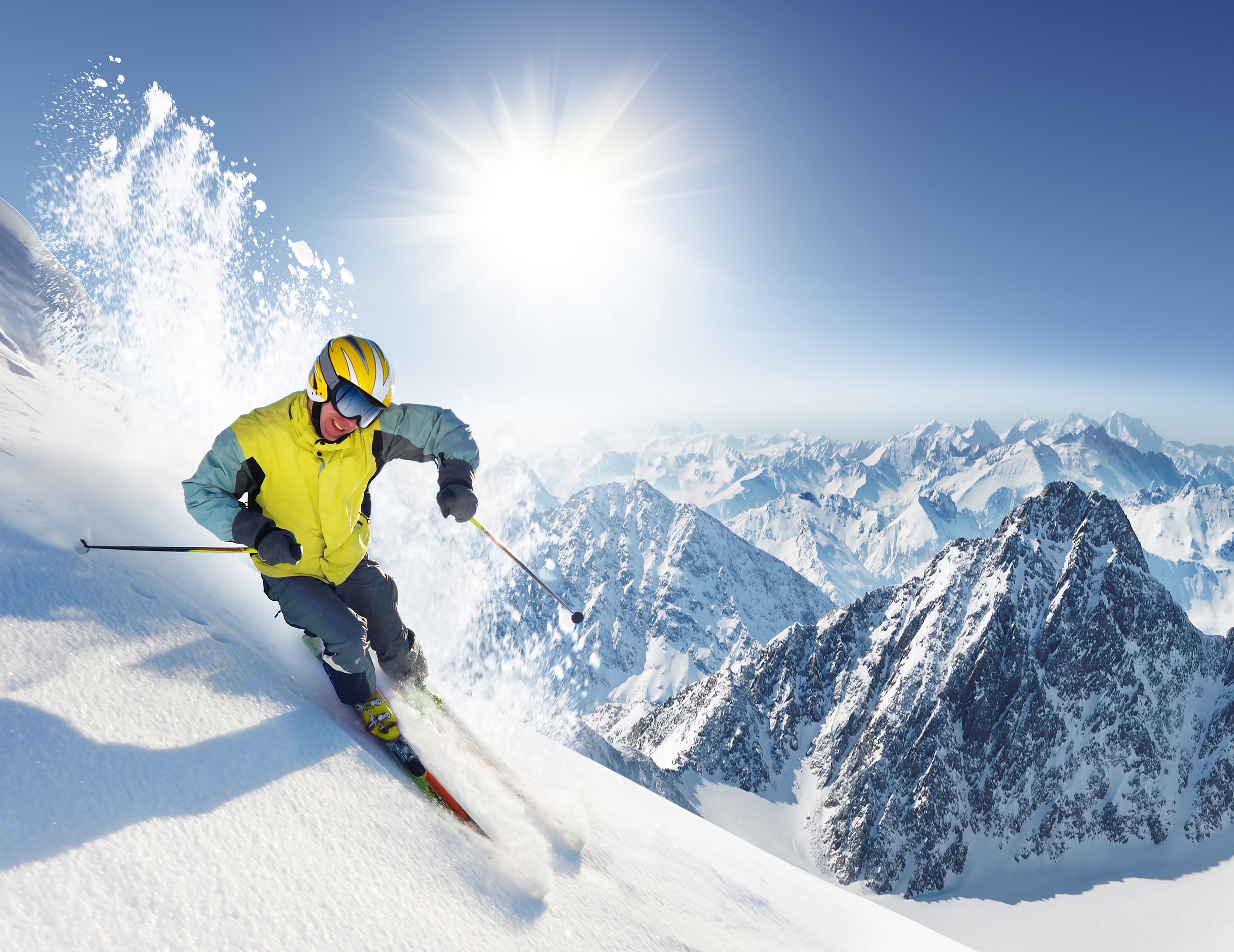 Man skiing down a snowy mountain under the sun HD Wallpaper