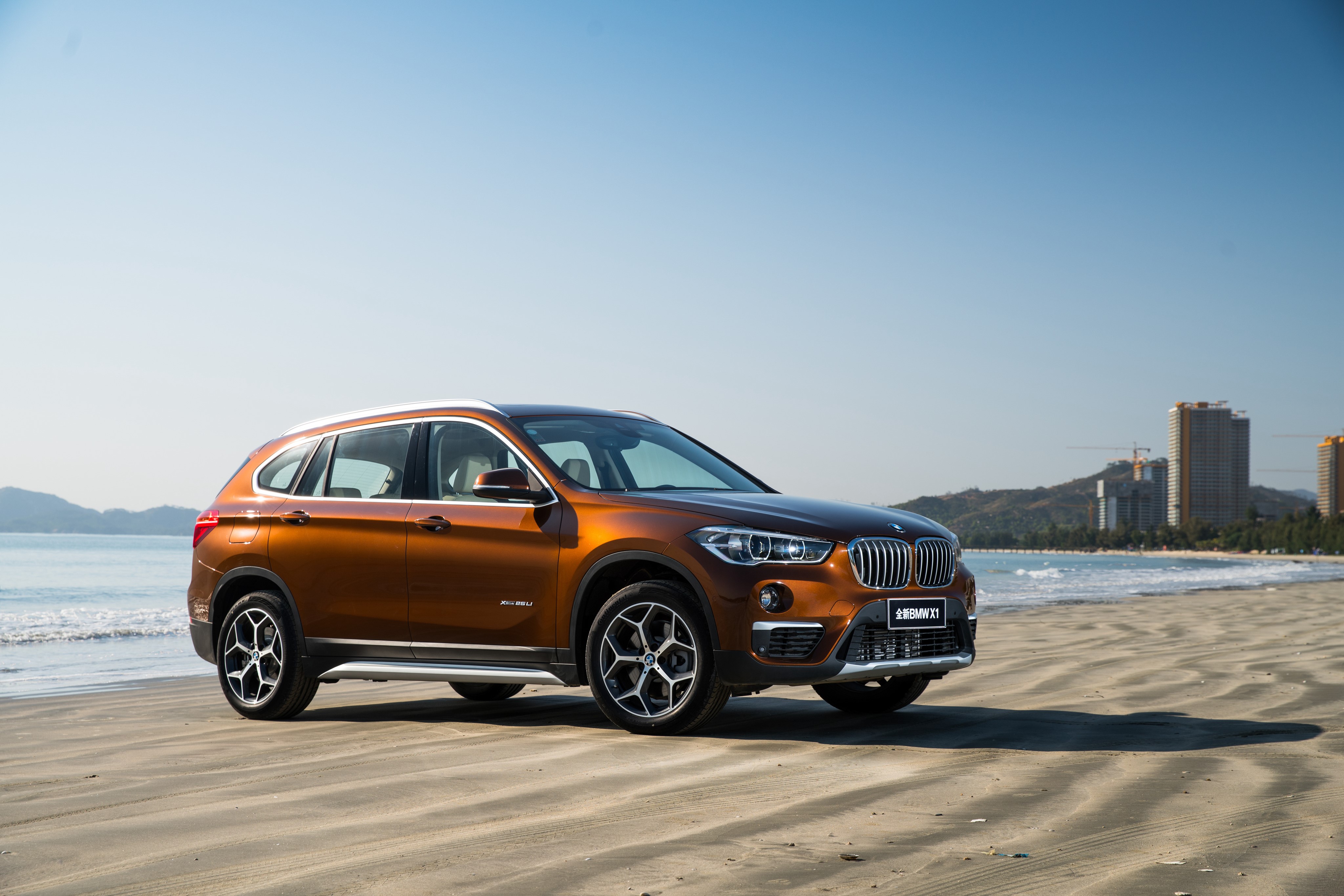 Brown BMW X1 Crossover on a Beach HD Wallpaper