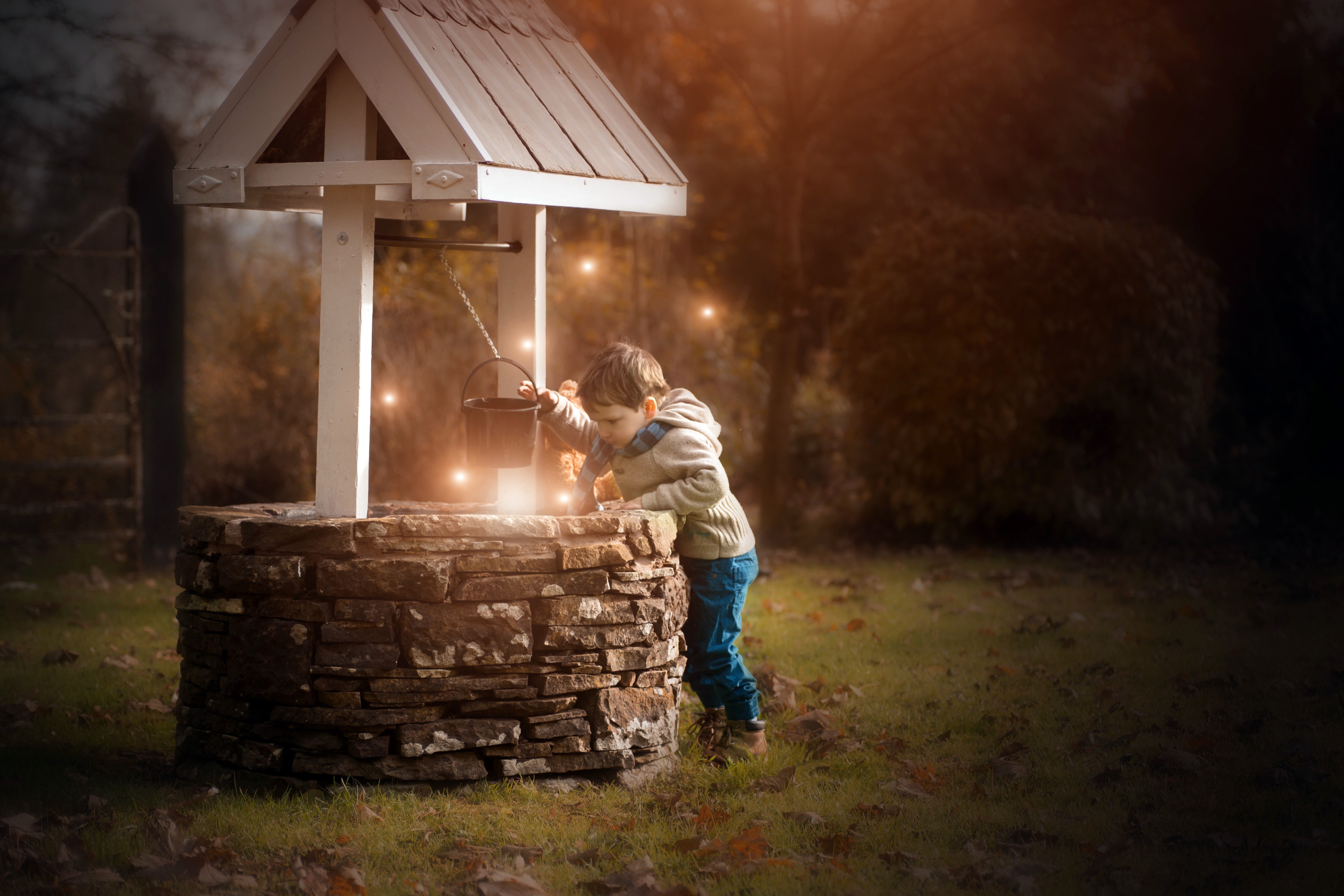 Boy at a Water Well with Lights HD Wallpaper