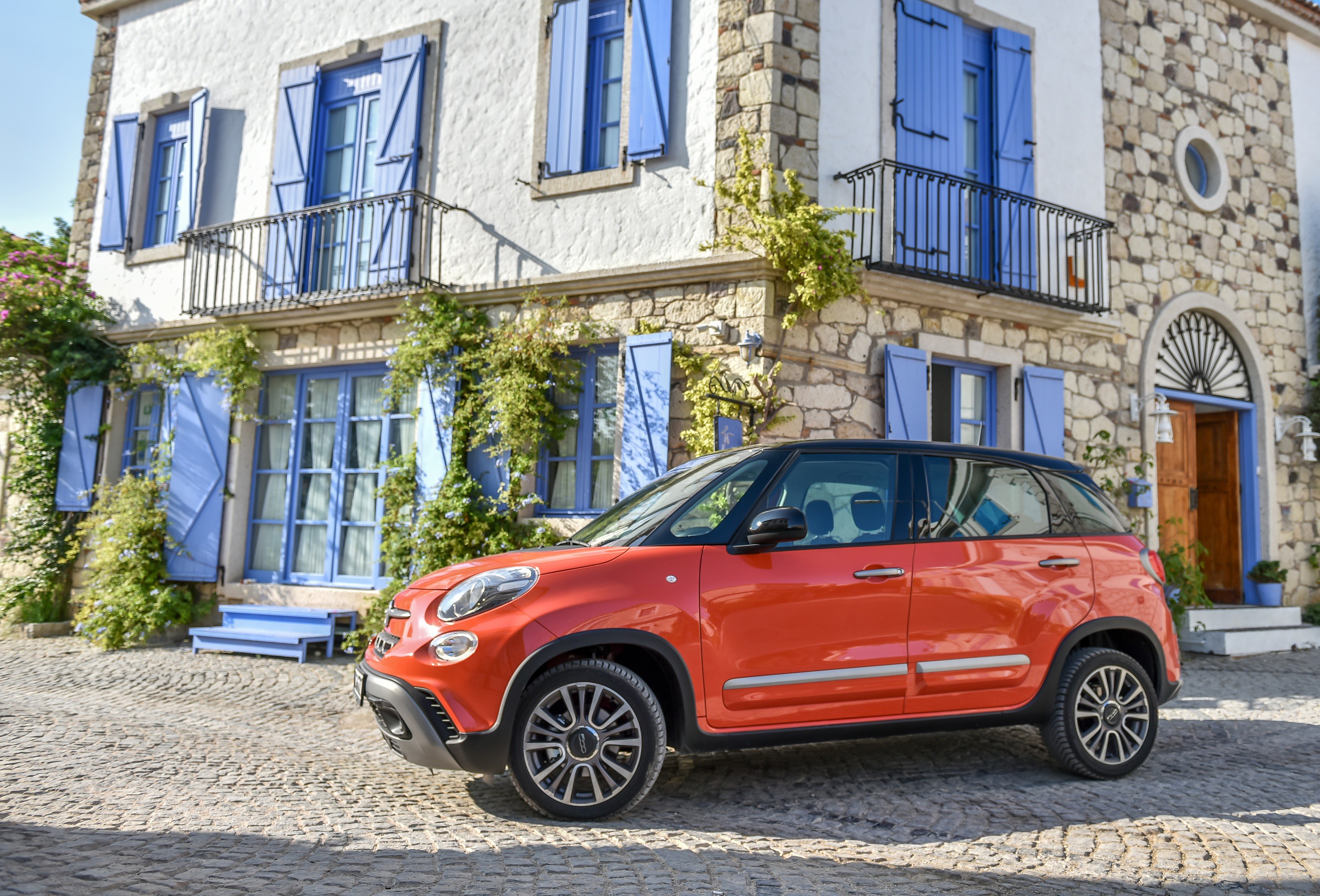 Orange Fiat 500L Cross parked in front of a stone house HD Wallpaper