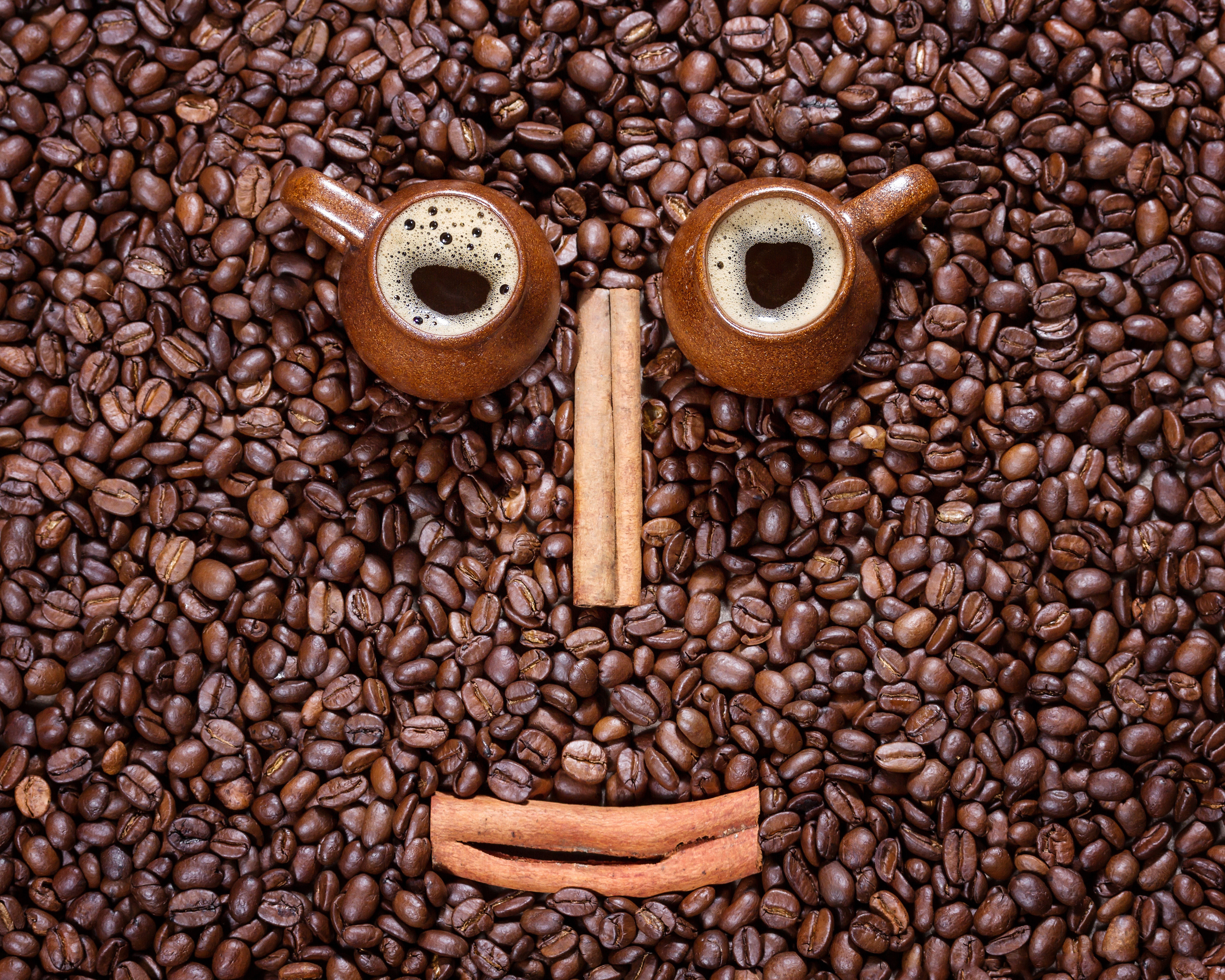Coffee beans with cups and cinnamon sticks HD Wallpaper
