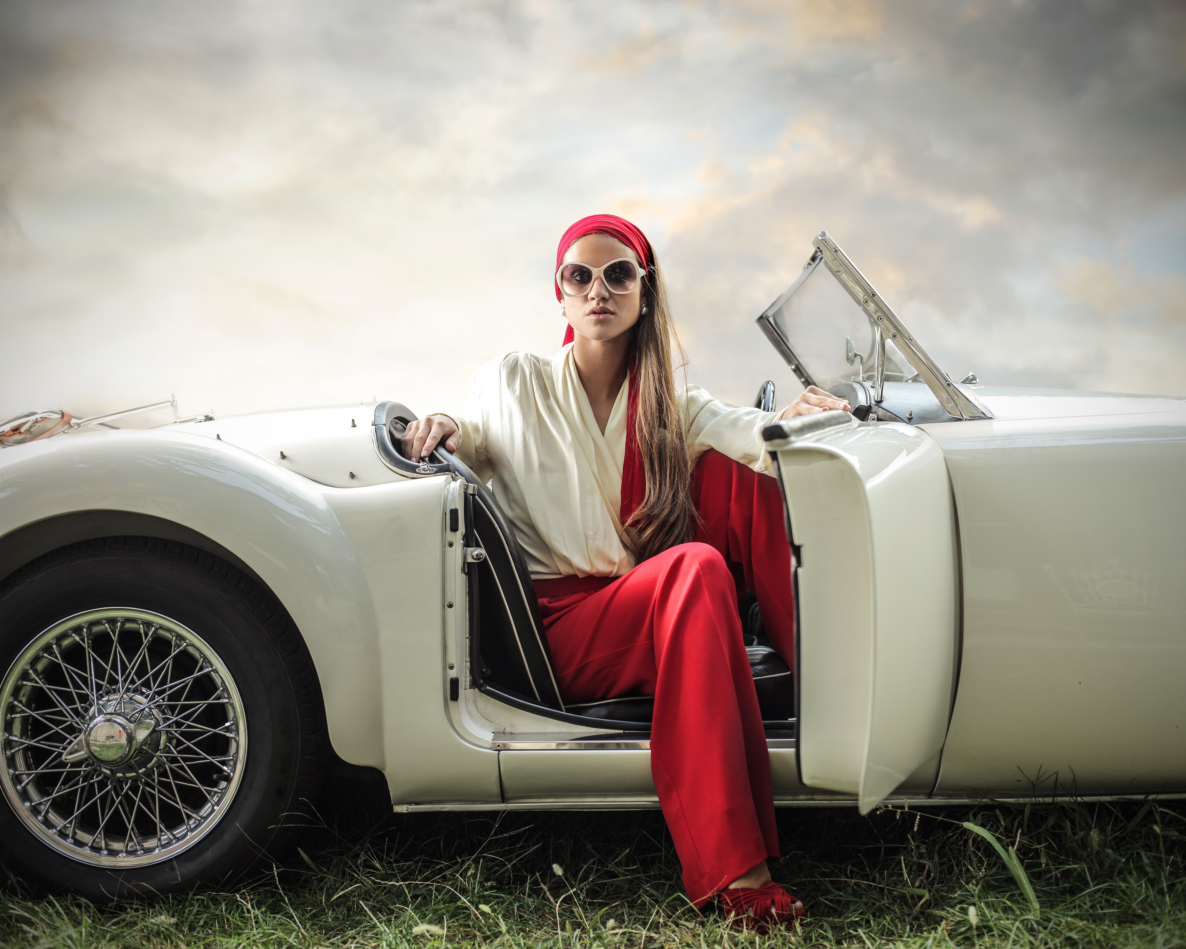 Woman in red pants and white shirt in a convertible HD Wallpaper